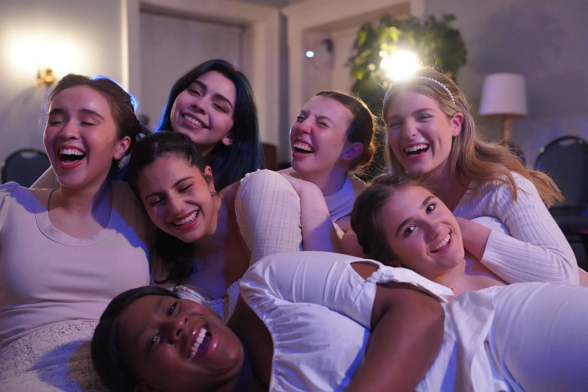 Group of young women laughing and smiling together.