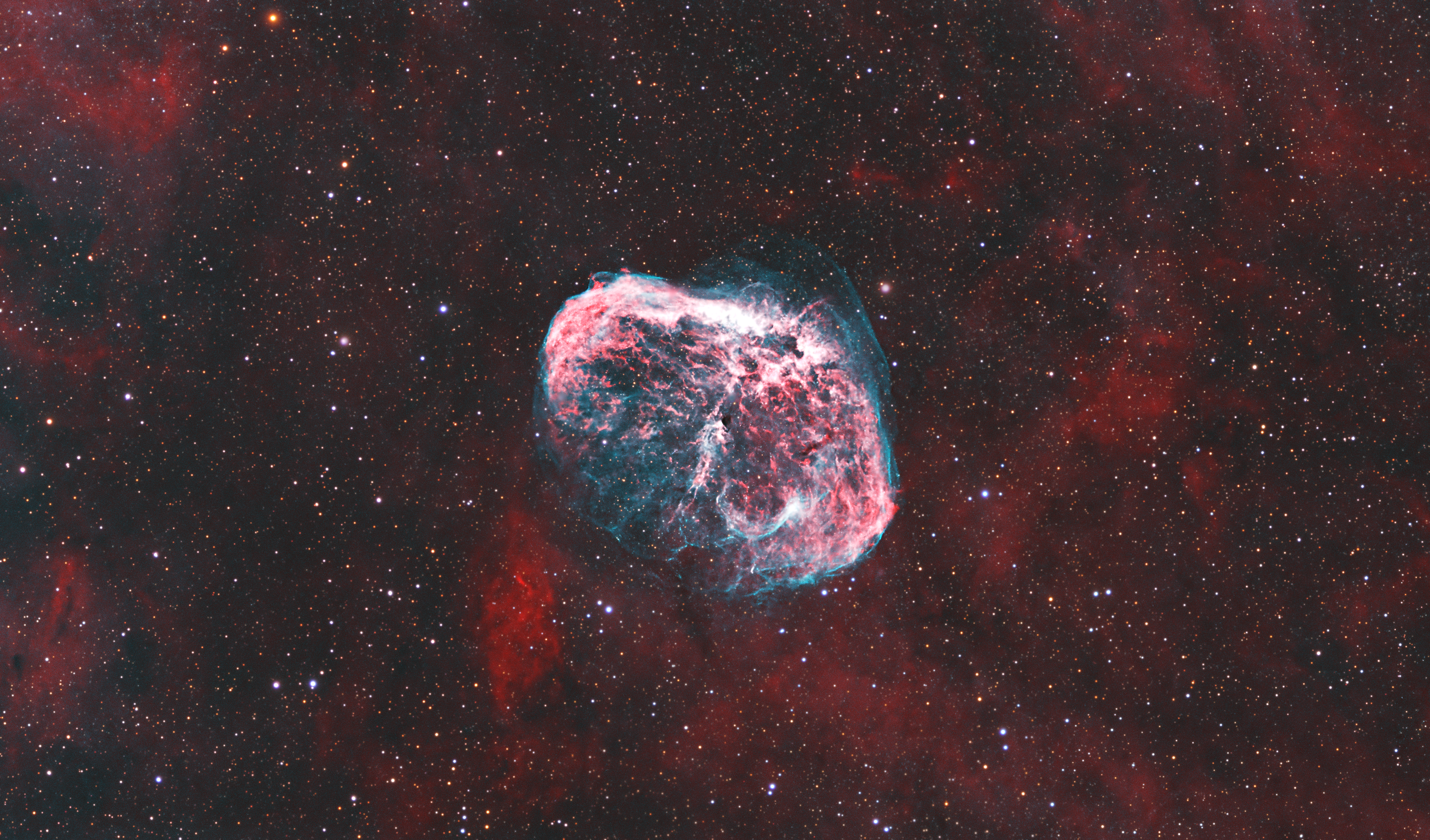 A colorful nebula in outer space with numerous stars.