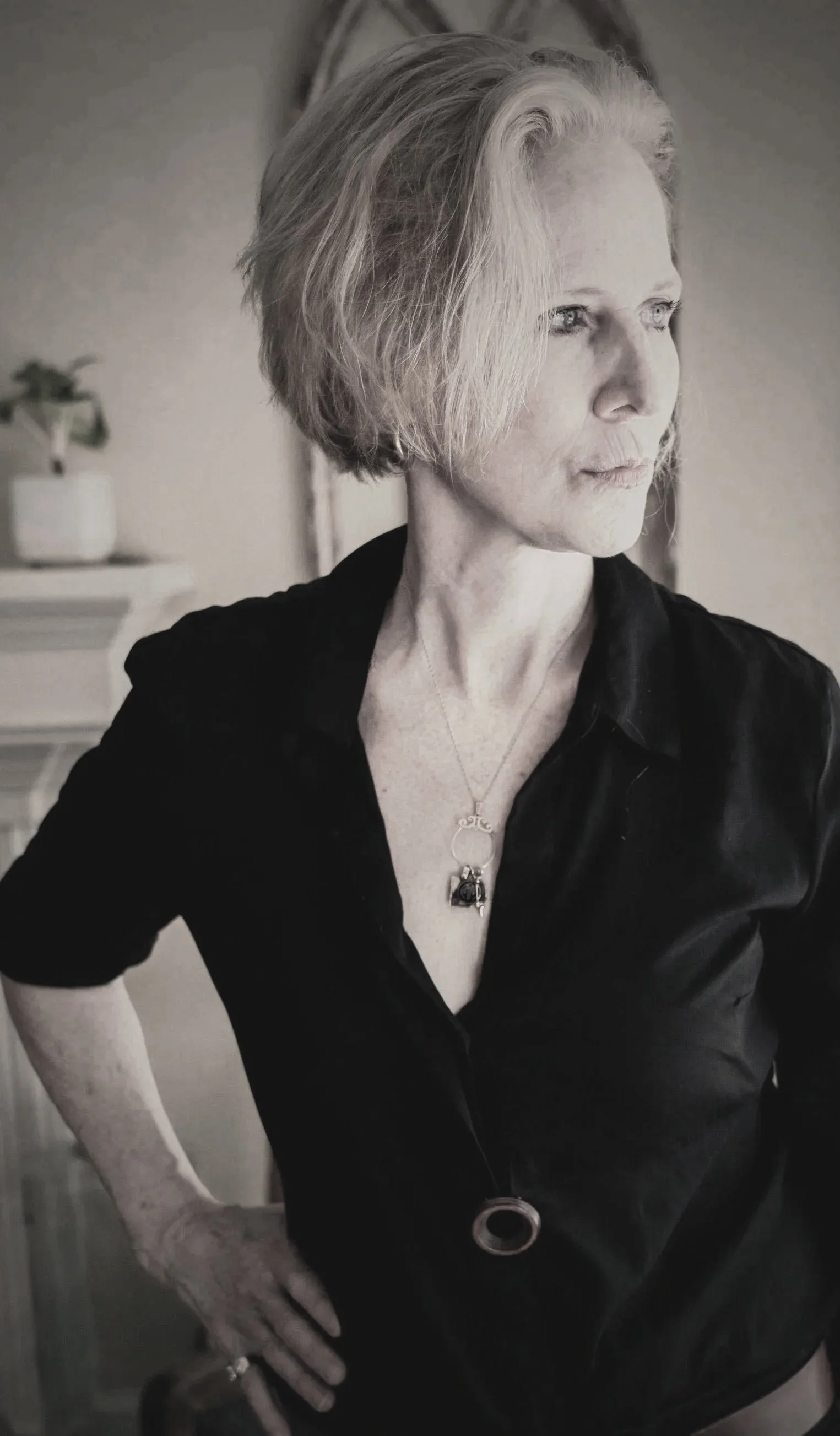women wiwth blond hair in black shirt staring