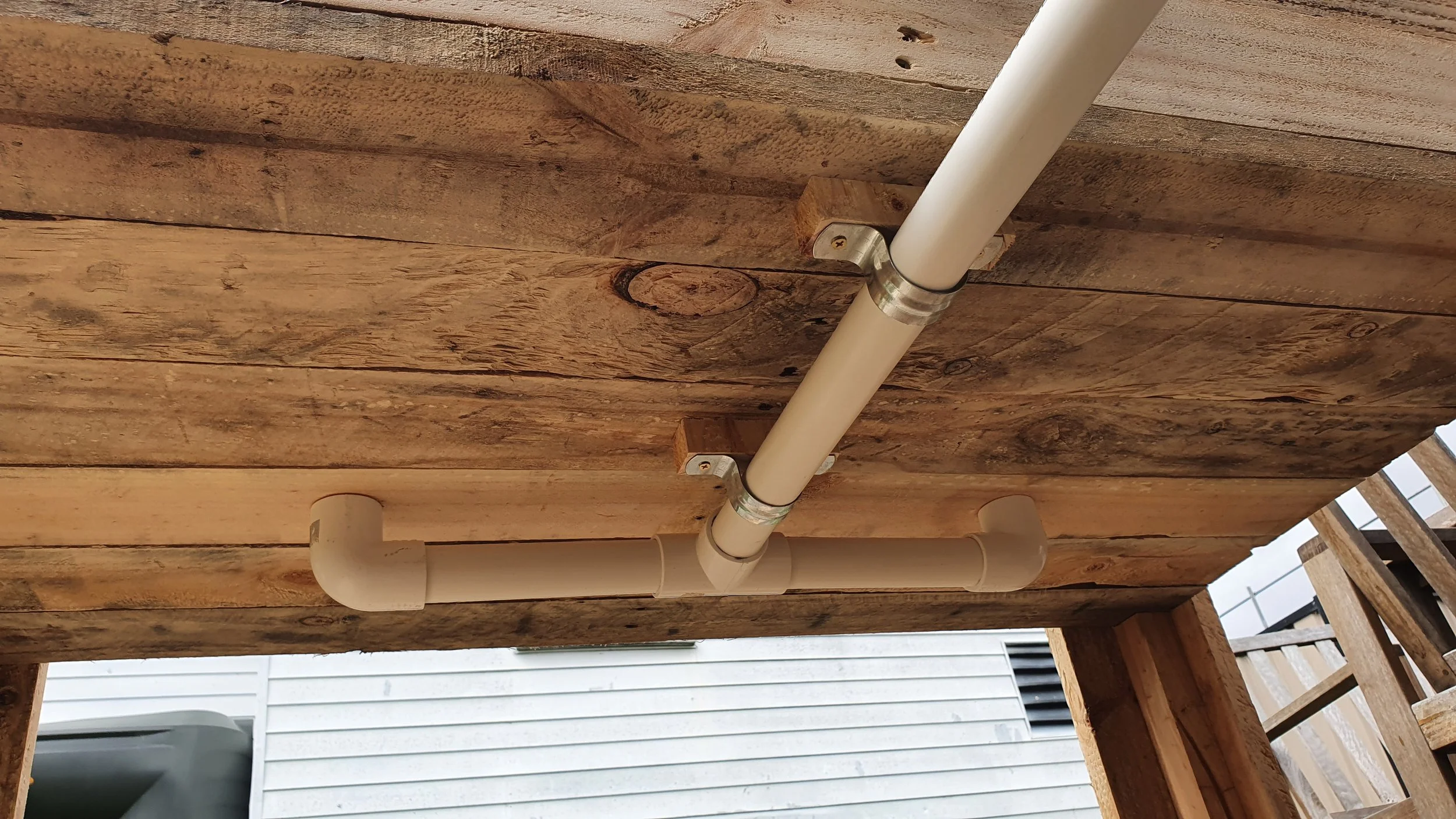 Pipes under planter box installed for excess water drainage