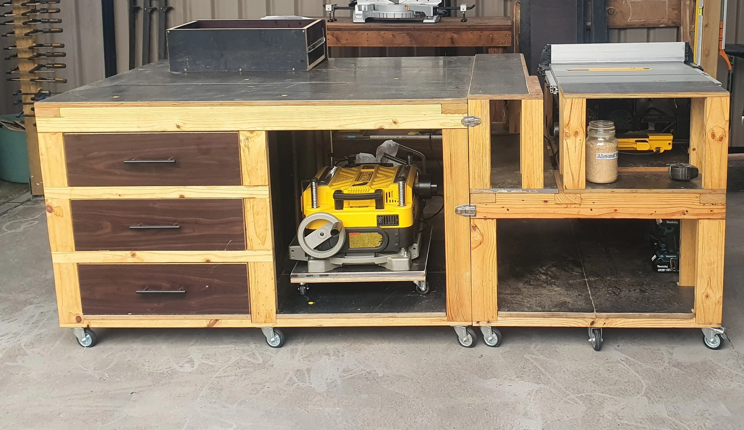 2-part mobile workbench made using repurposed pallet wood; made to fit a DeWalt DWE7491 table saw
