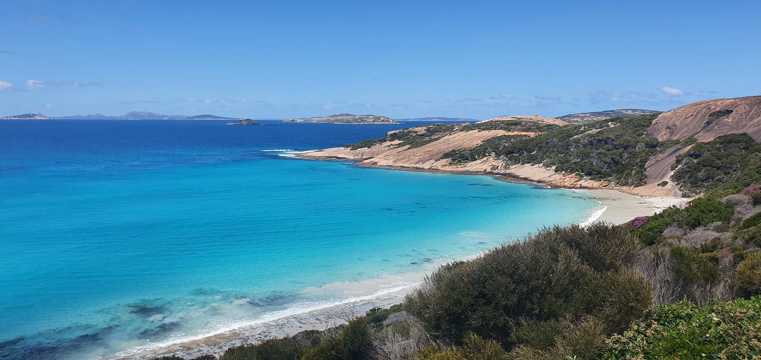 Aerial view of Esperance coastline with vibrant blue ocean and rugged headlands, evoking tranquillity and resilience – HK Psychological Services Perth telehealth.