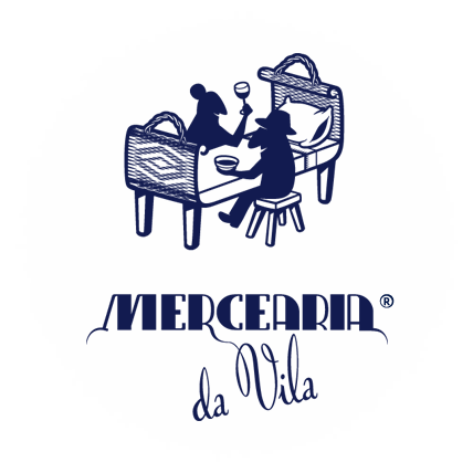 A mountain landscape with snow-capped peaks in the background and a modern building on a grassy hillside in the foreground.