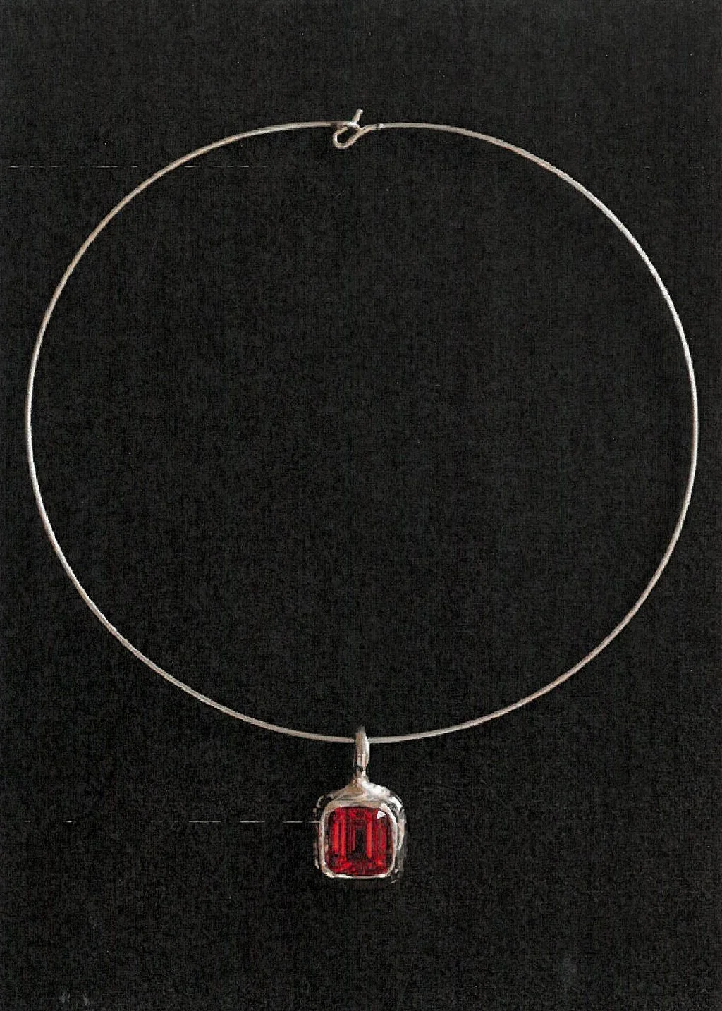 Silver choker necklace with rectangular red gemstone pendant on black background.