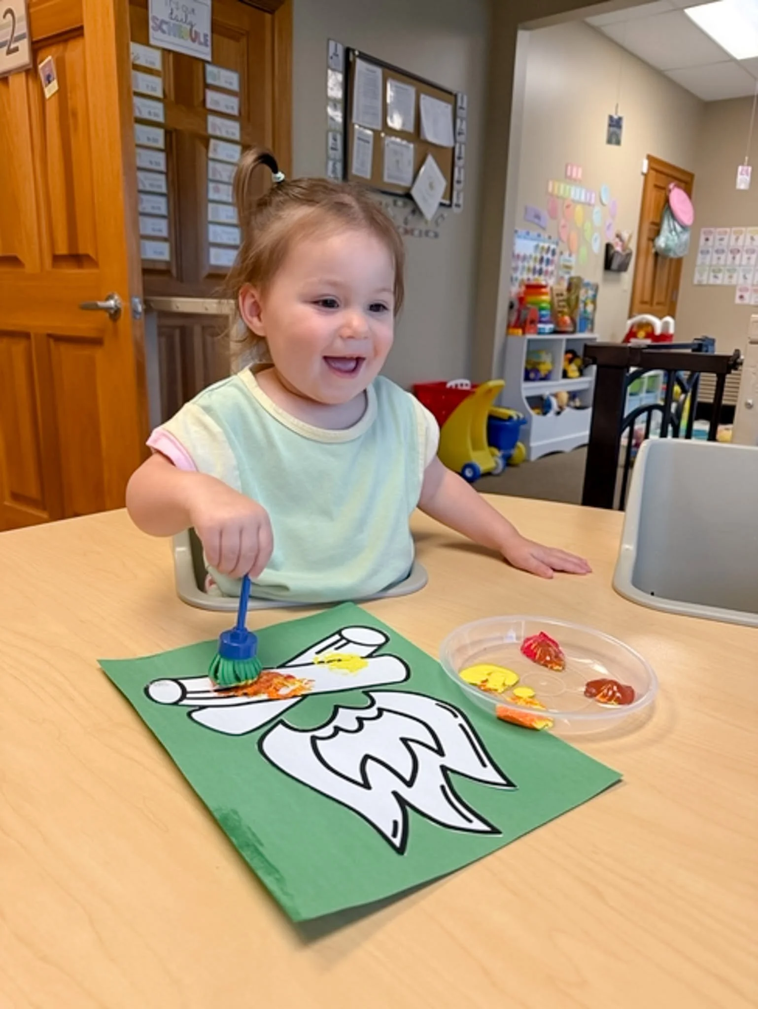 Toddler painting a craft at Branch & Bloom childcare in Burlington, KY