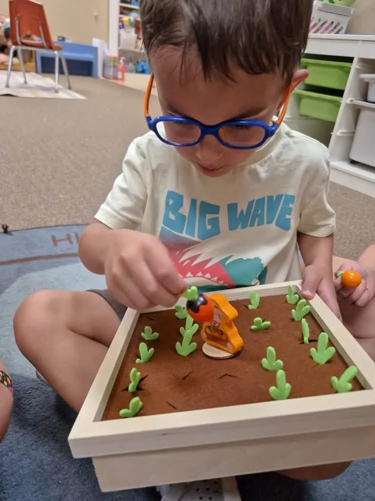 Preschooler engaged in hands-on learning at Branch & Bloom preschool in Burlington, KY