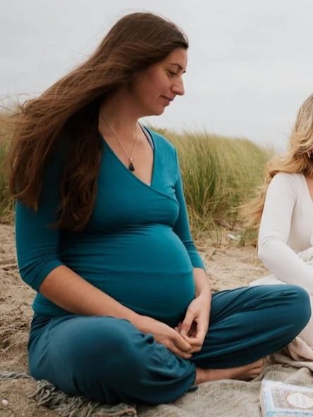 Pregnant woman writing down questions and considering her options