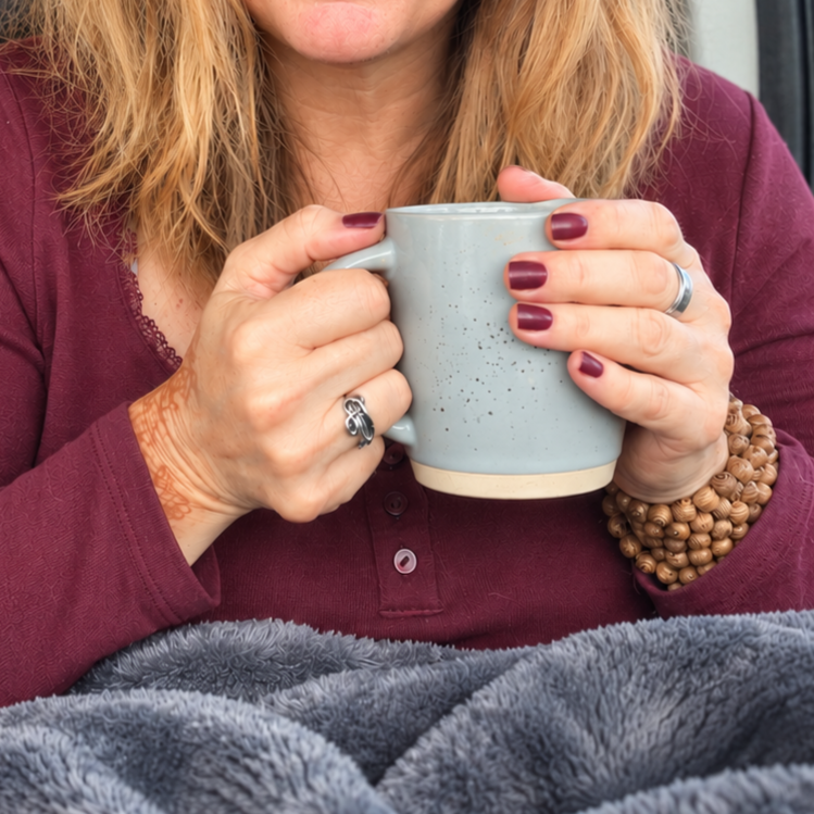 Two women talking together over a cup of tea