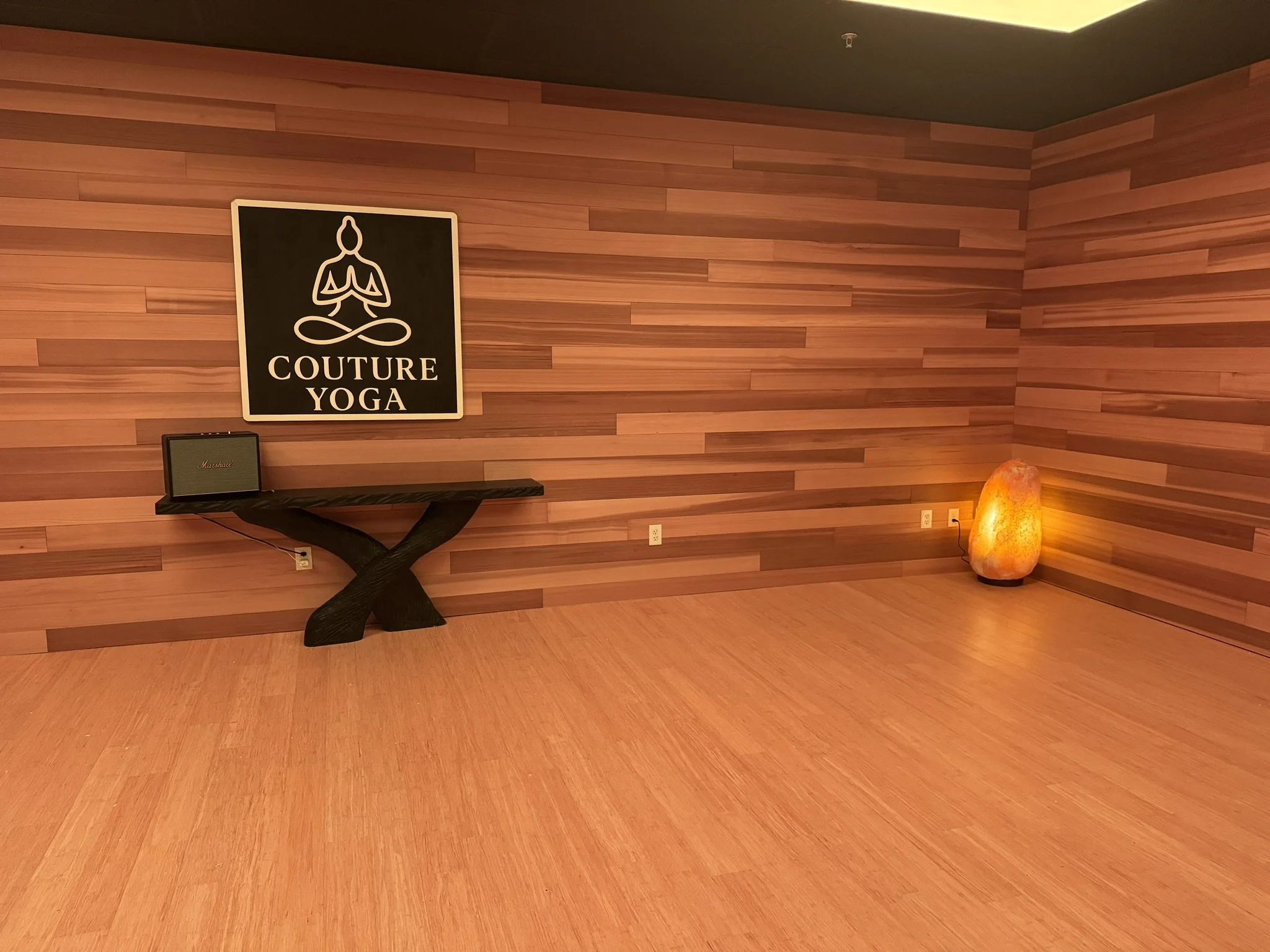 The Couture Yoga Sanctuary Room with cedar walls, bamboo floors, a 300lb Himalayan Salt Lamp in the corner.
