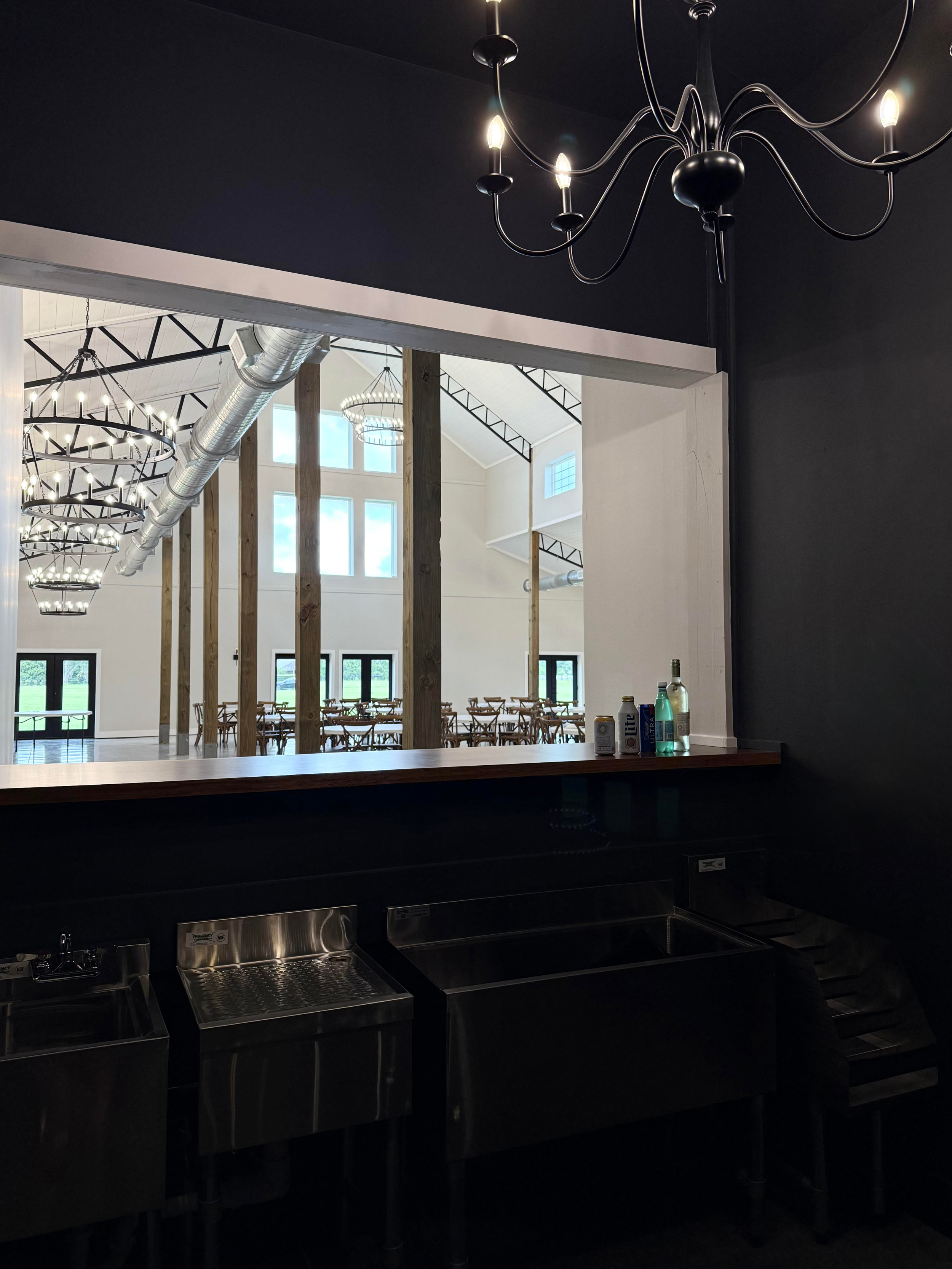 Indoor bar with wooden top and server access from behind the counter for drink service or cocktail hour.