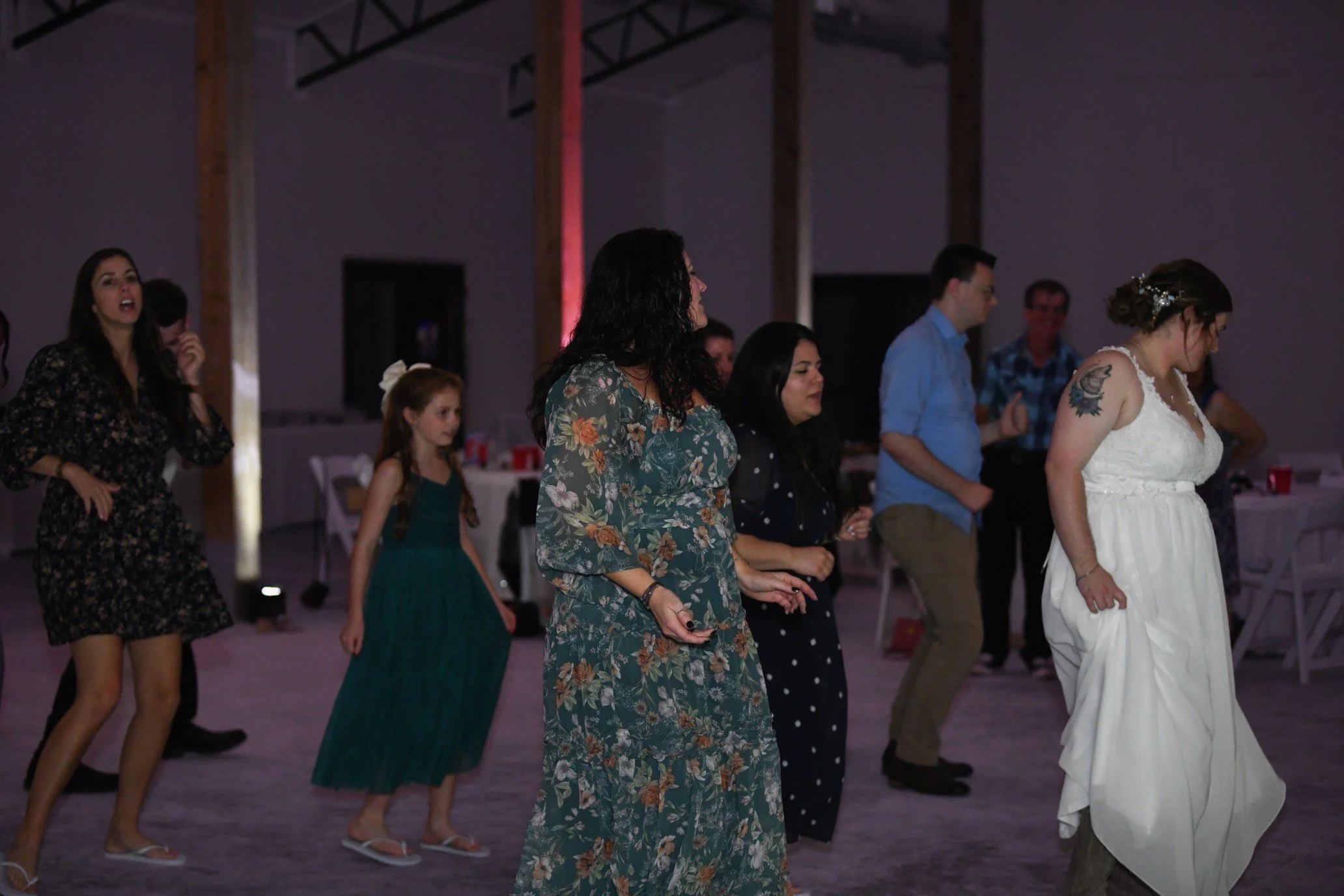 Guests dining and dancing inside spacious Southern wedding reception hall.