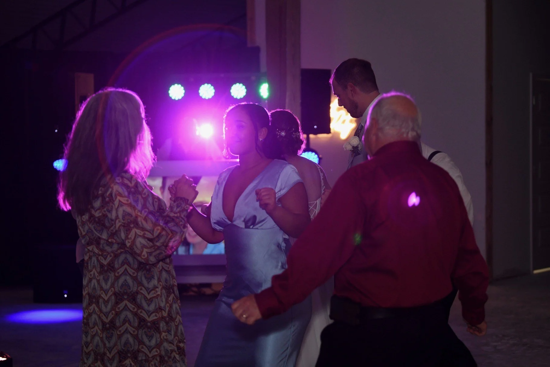 Guests dining and dancing inside spacious Southern wedding reception hall.