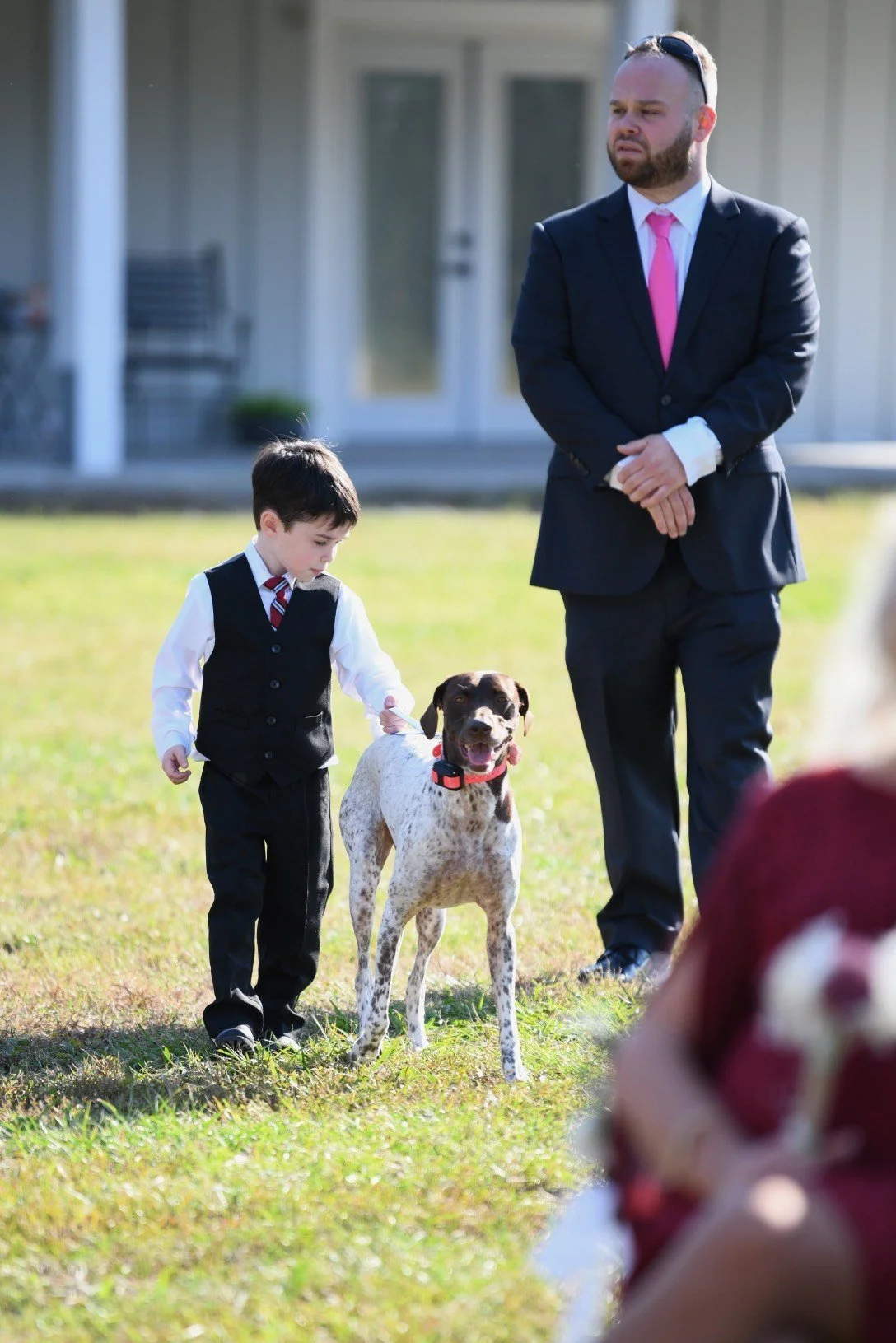 Ring bearer walking down the isle with the family dog.