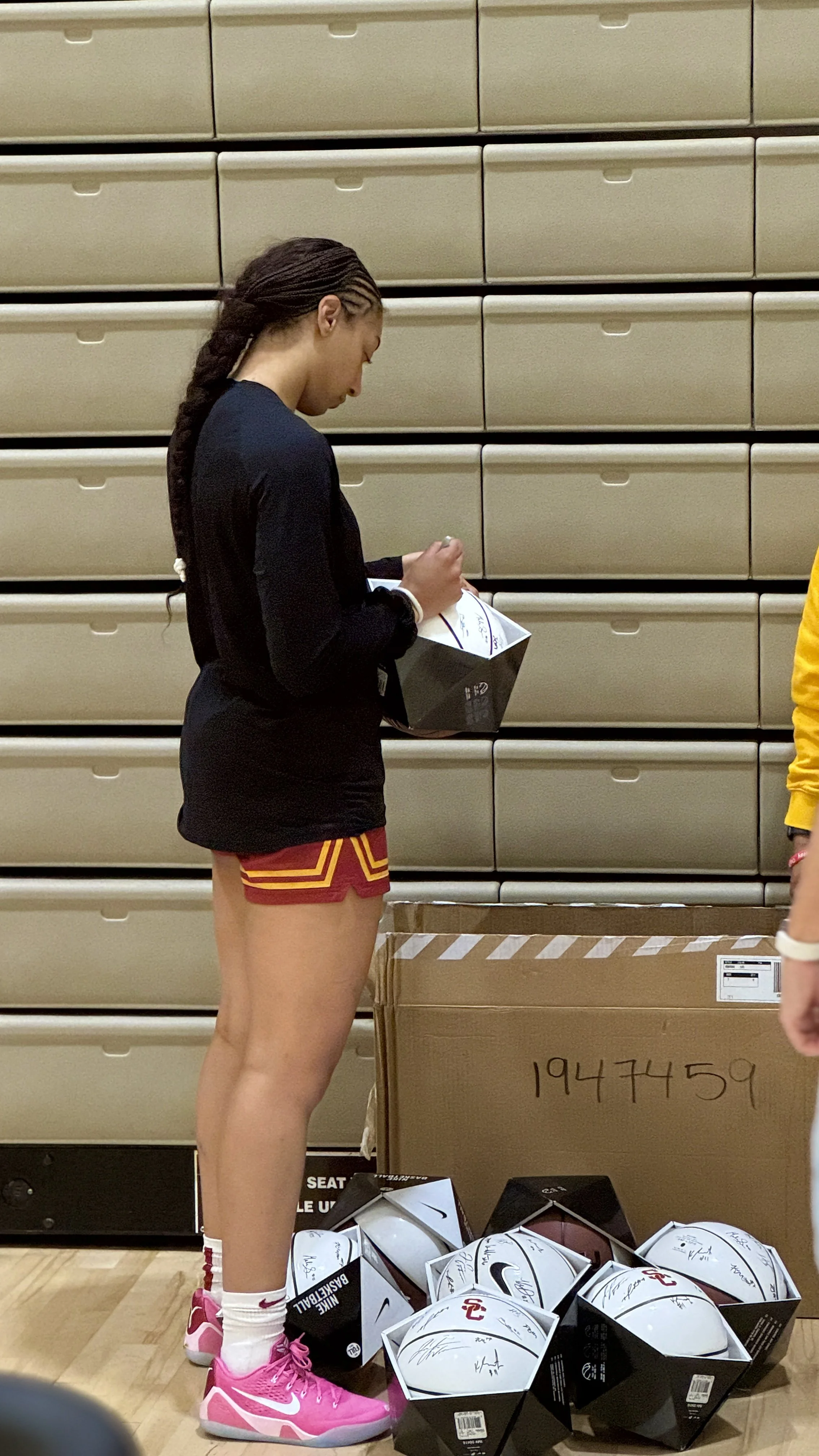 Ken Dawg Siging a Basketball for an Event