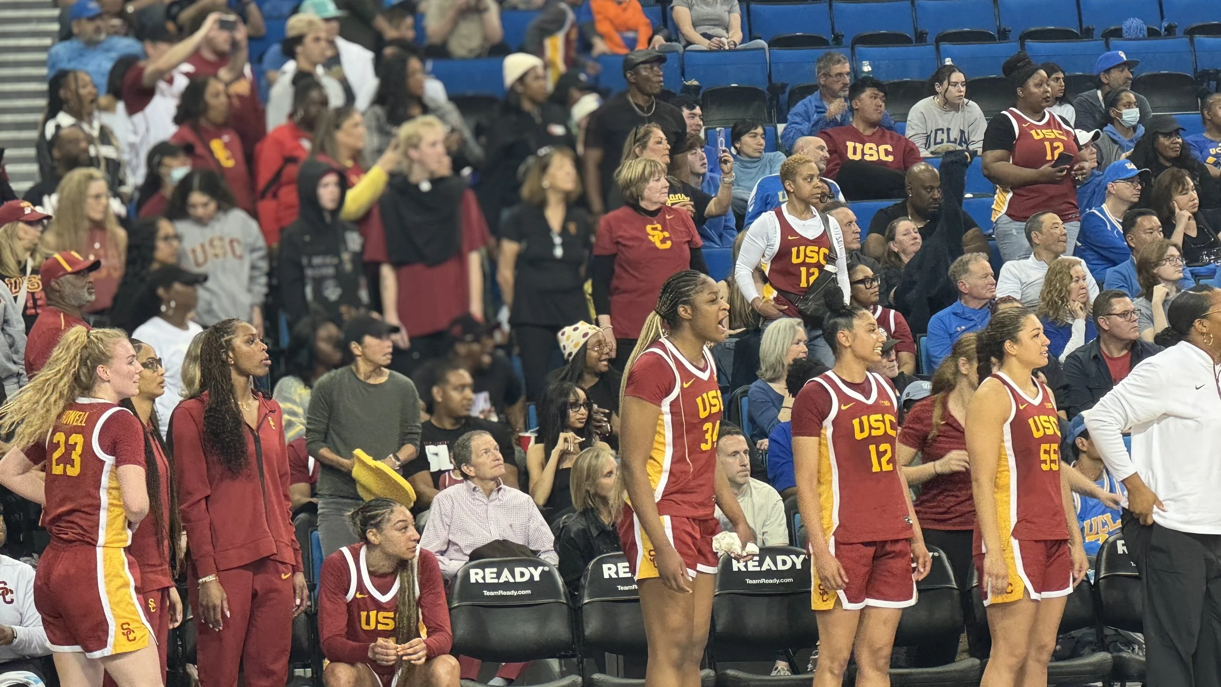 UCS women's bb players cheering on team from bench