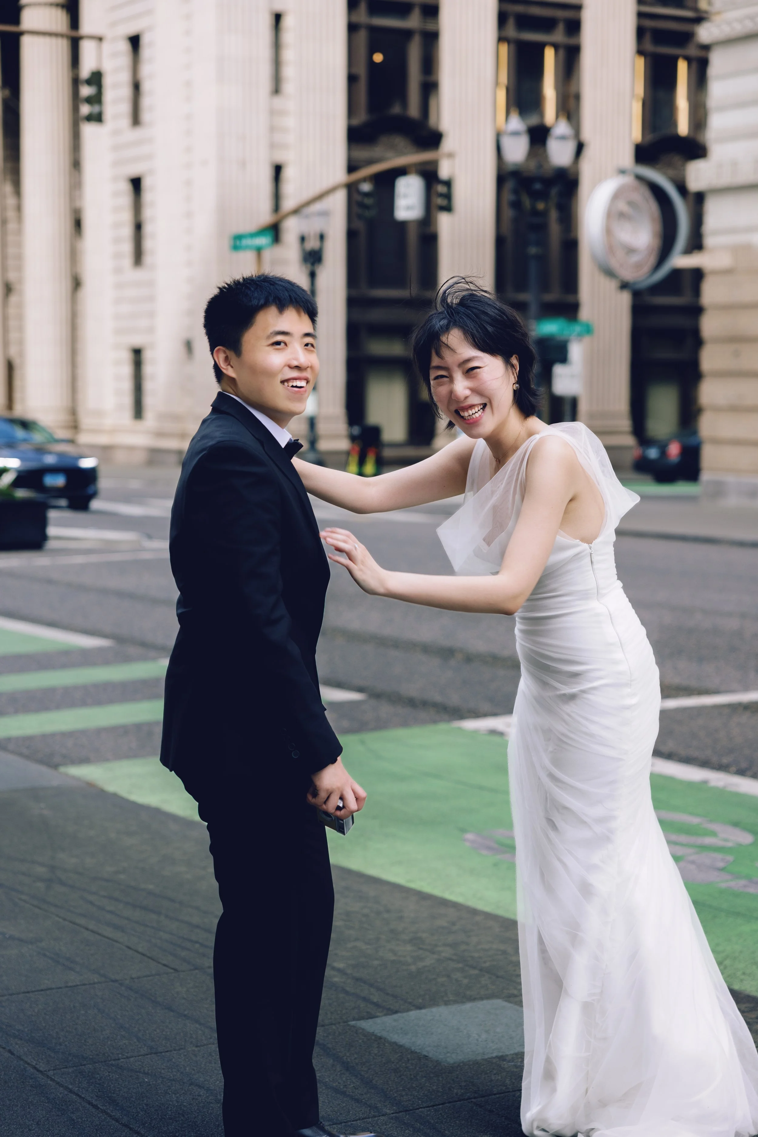 Couple laughing together during a downtown Portland engagement session.