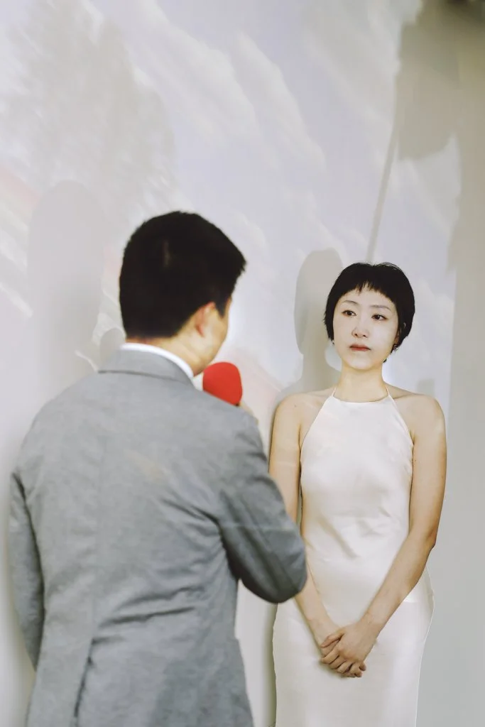 The groom reads a personal letter to the bride during a quiet, emotional moment.