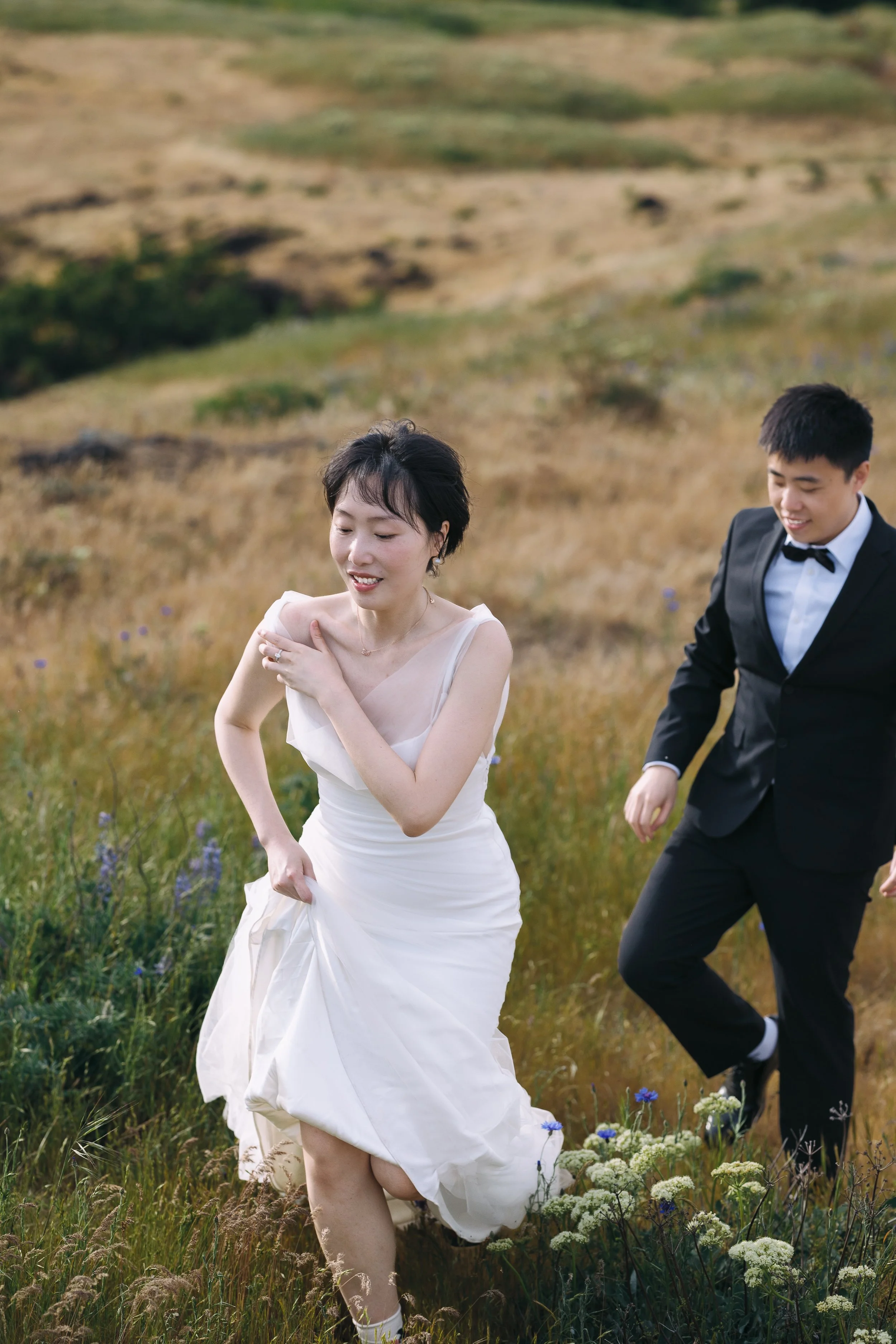 Couple walking through spring wildflowers at Tom McCall Preserve in Oregon.