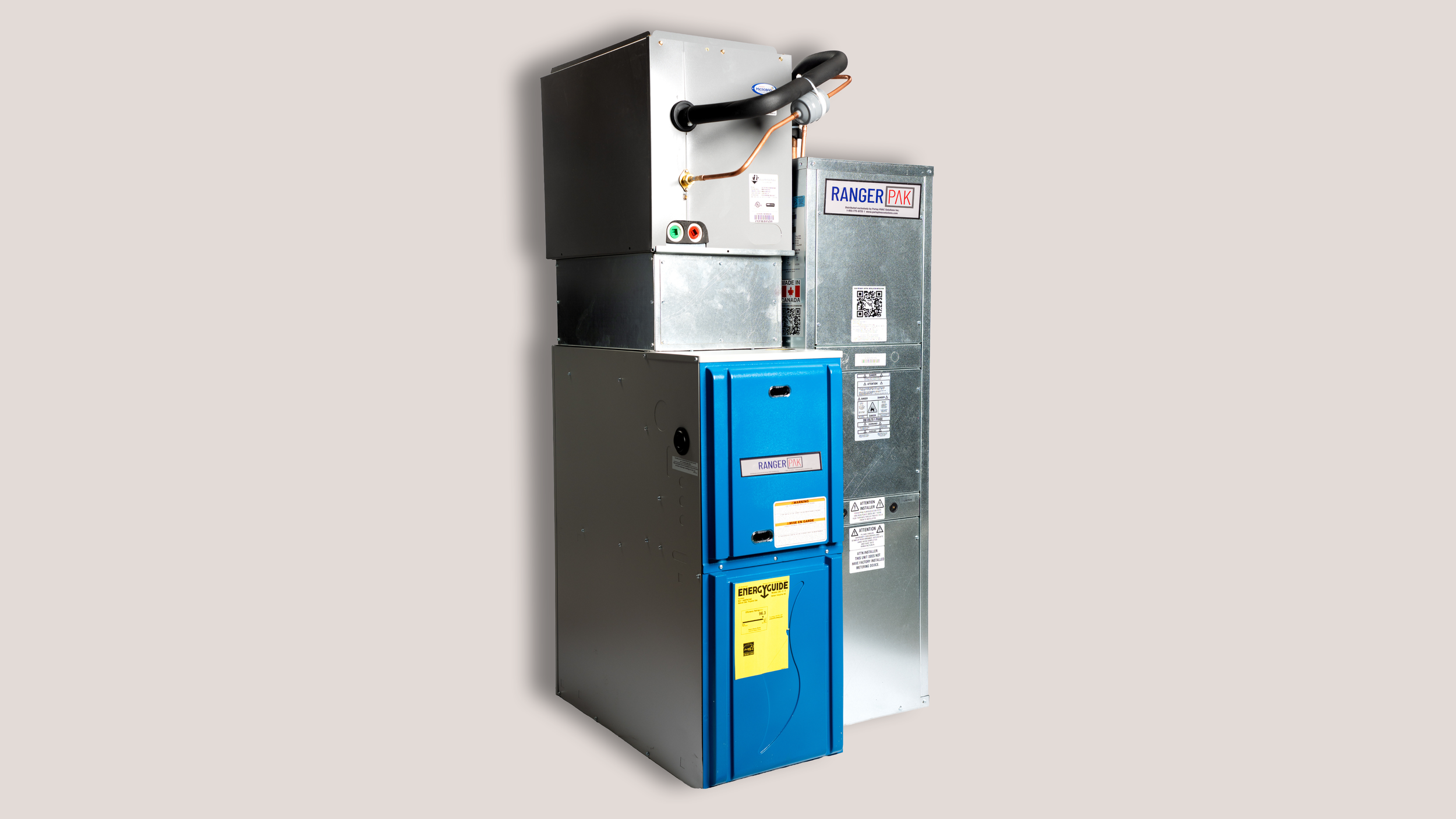A metal electrical HVAC unit with multiple panels and labels, placed against a plain white wall.