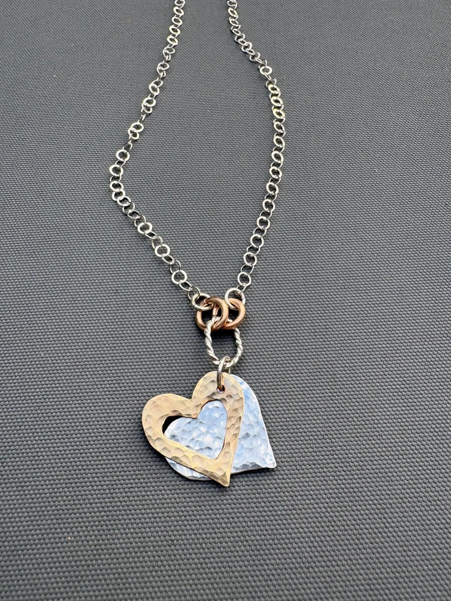 Thought I&rsquo;d share my new creation.  This Sterling silver necklace with 2 hearts gently hammered in Silver and Bronze.  #sterlingsilverjewelry #heart #bronze