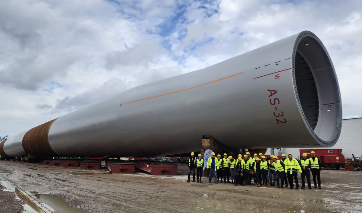 Vineyard Offshore team alongside an offshore wind monopile foundation at the Rostock, Germany manufacturing facility (author is second from left).