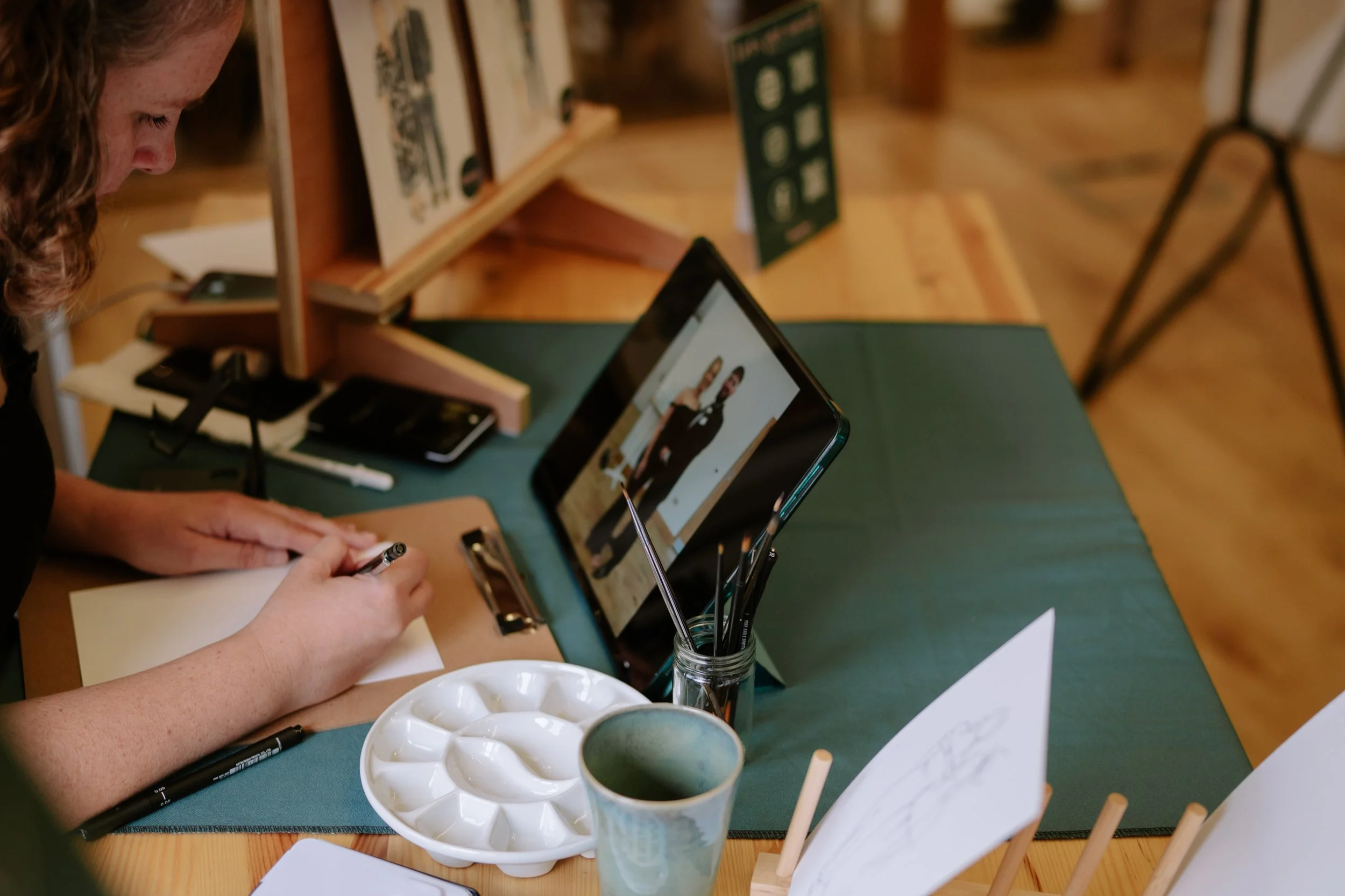 Watercolour artist painting guests at wedding