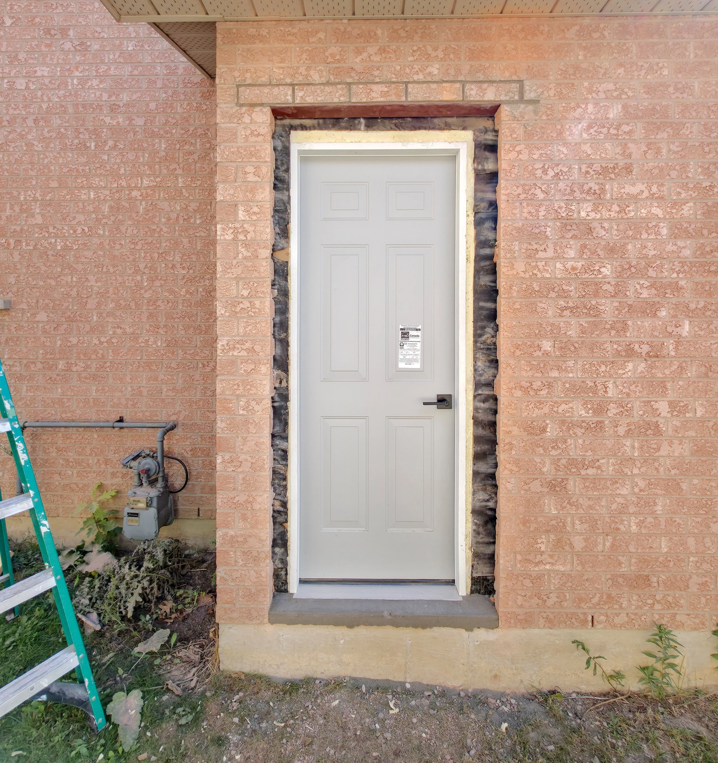 Steel side entrance door installation before trim and finishing – Pam Arc Inc.