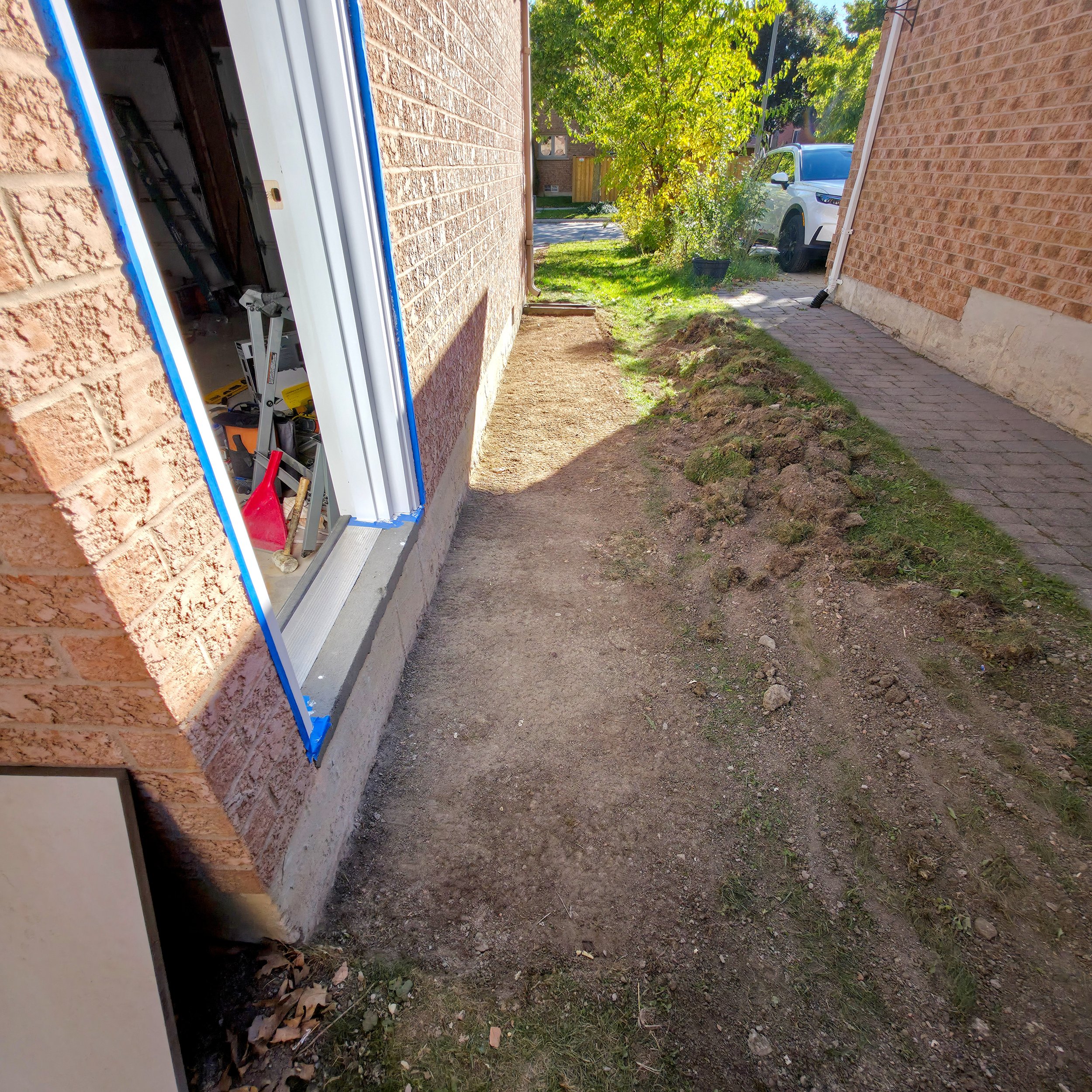Leveling ground for walkway beside new side entrance door – Pam Arc Inc.