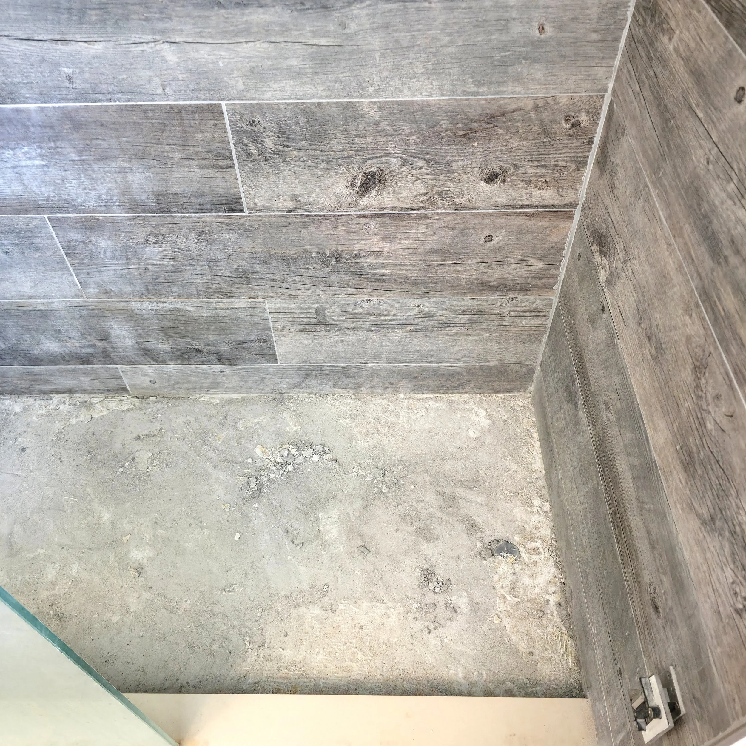Bathroom Renovation in Richmond Hill, Ontario with demolished shower floor, exposing the sub-base