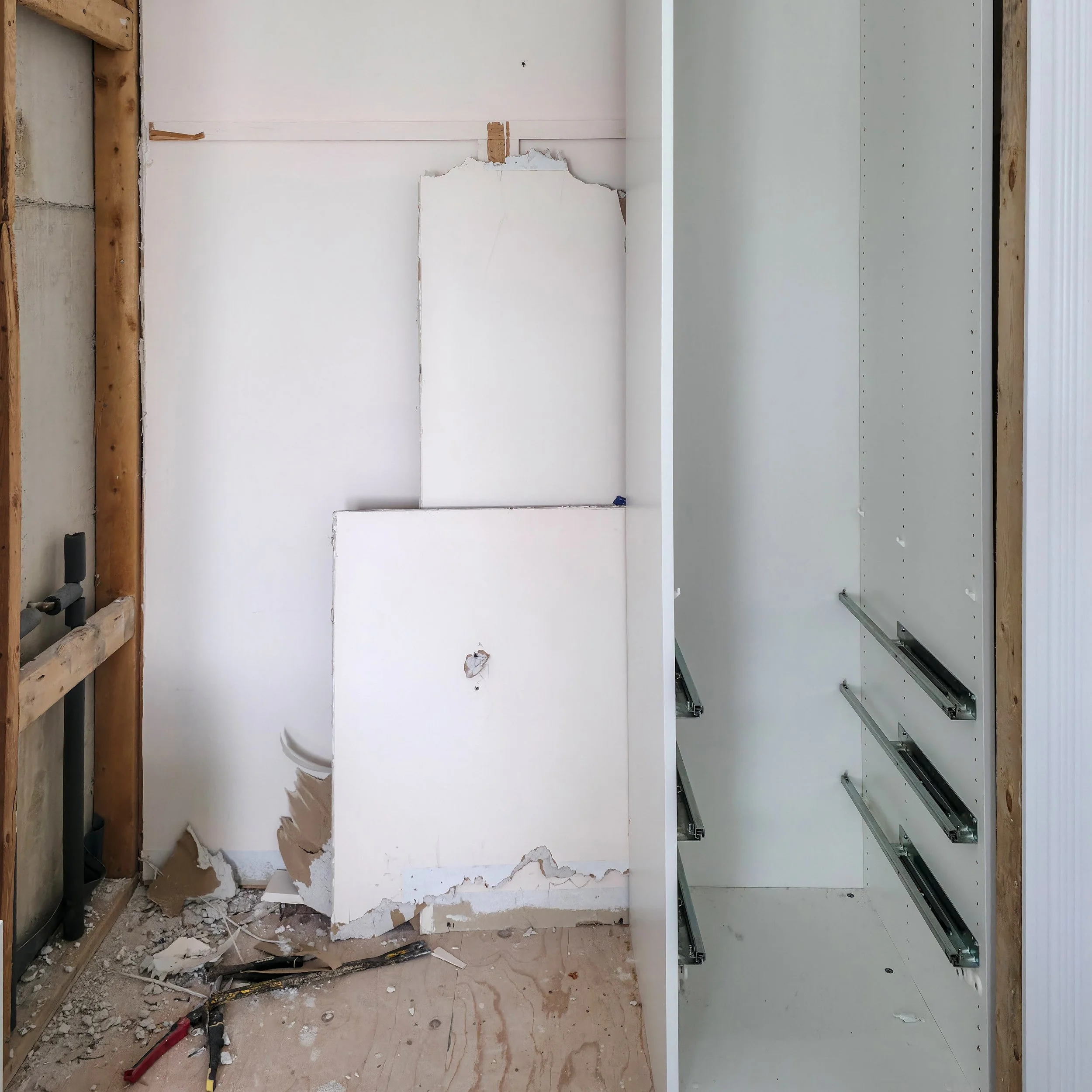 Bathroom renovation in Richmond Hill, Ontario, the closet behind the shower is removed to give access to the plumbing behind