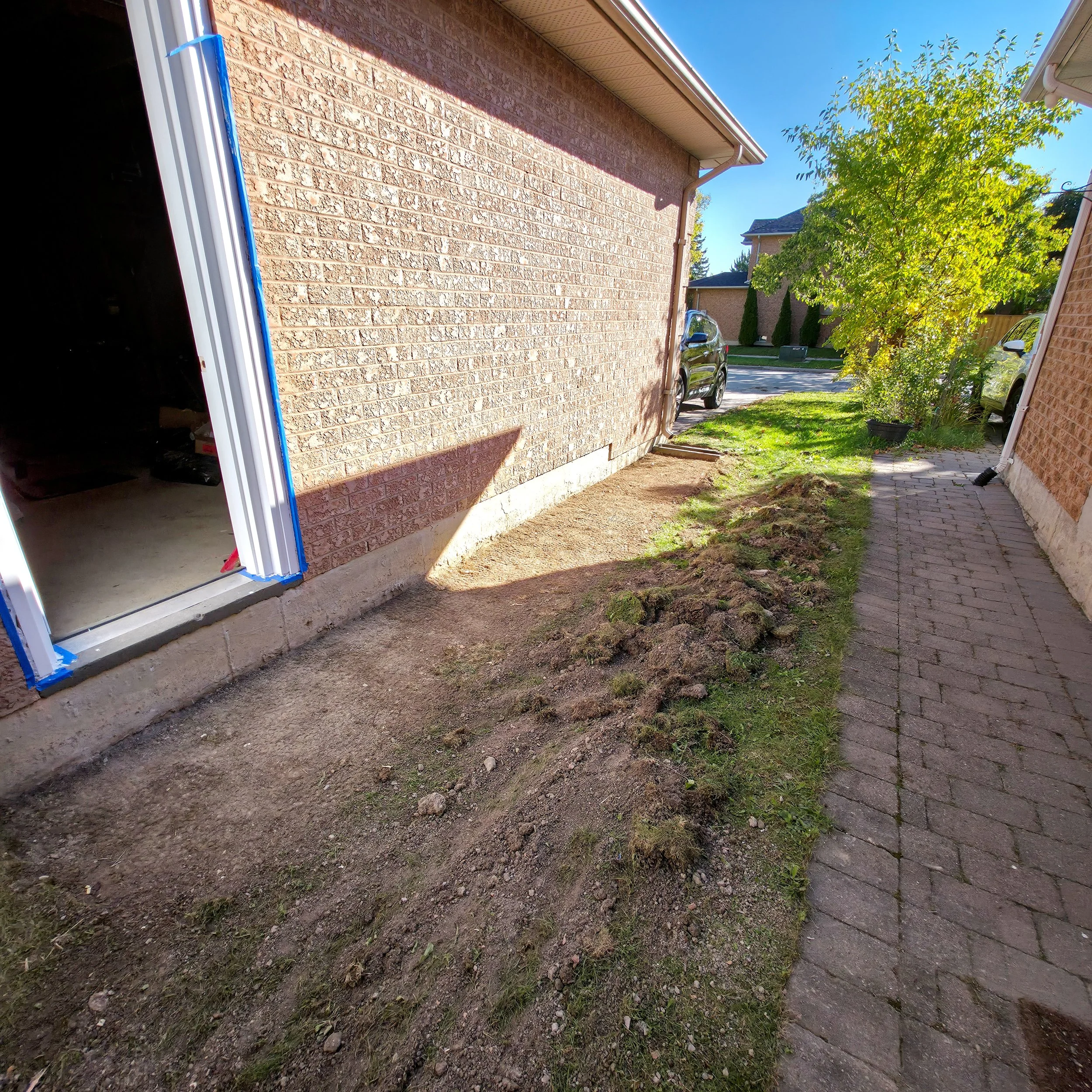 Ground preparation for walkway beside new side entrance in Richmond Hill – Pam Arc Inc.