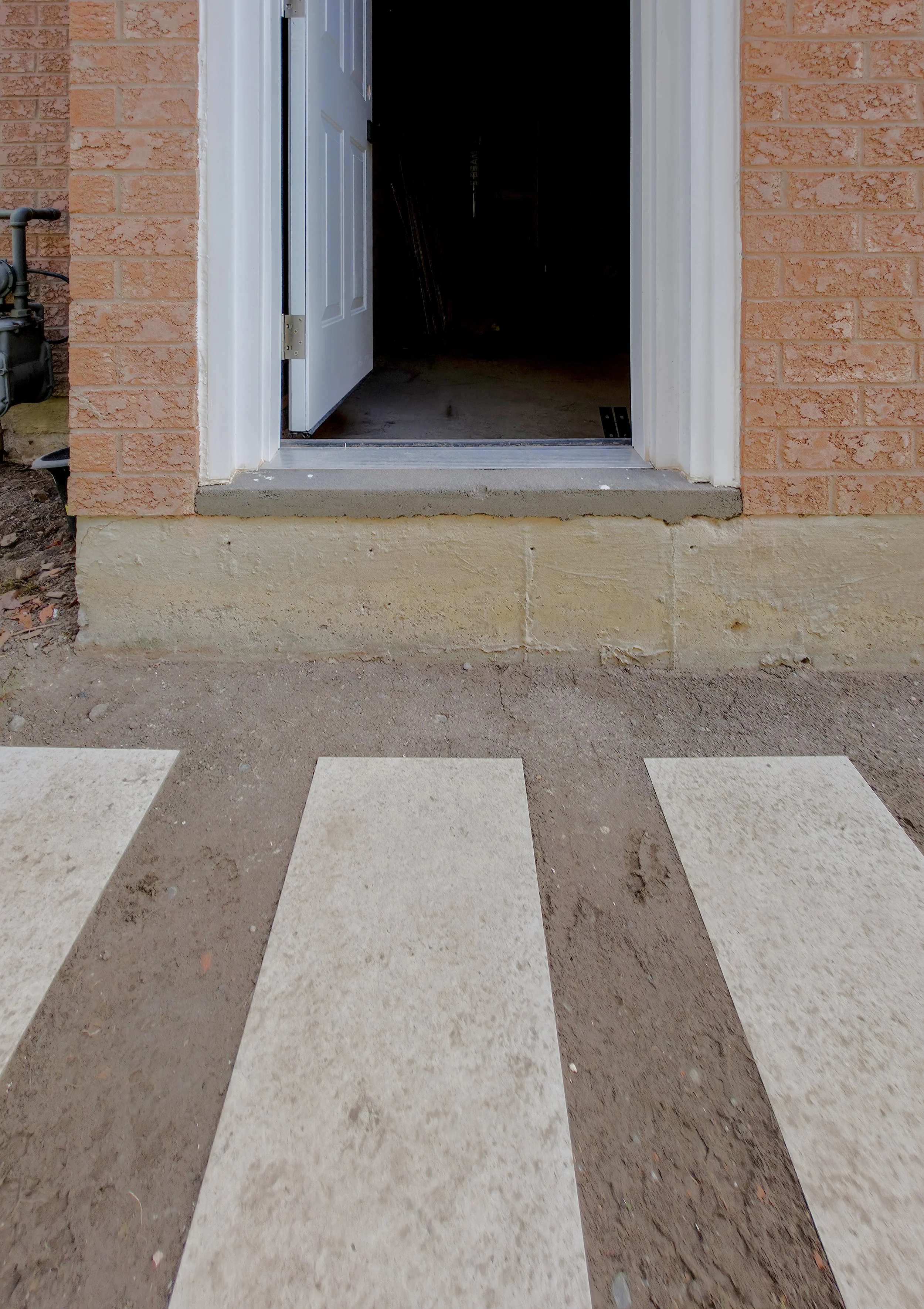 Quartz walkway base set before wooden step installation – Pam Arc Inc.