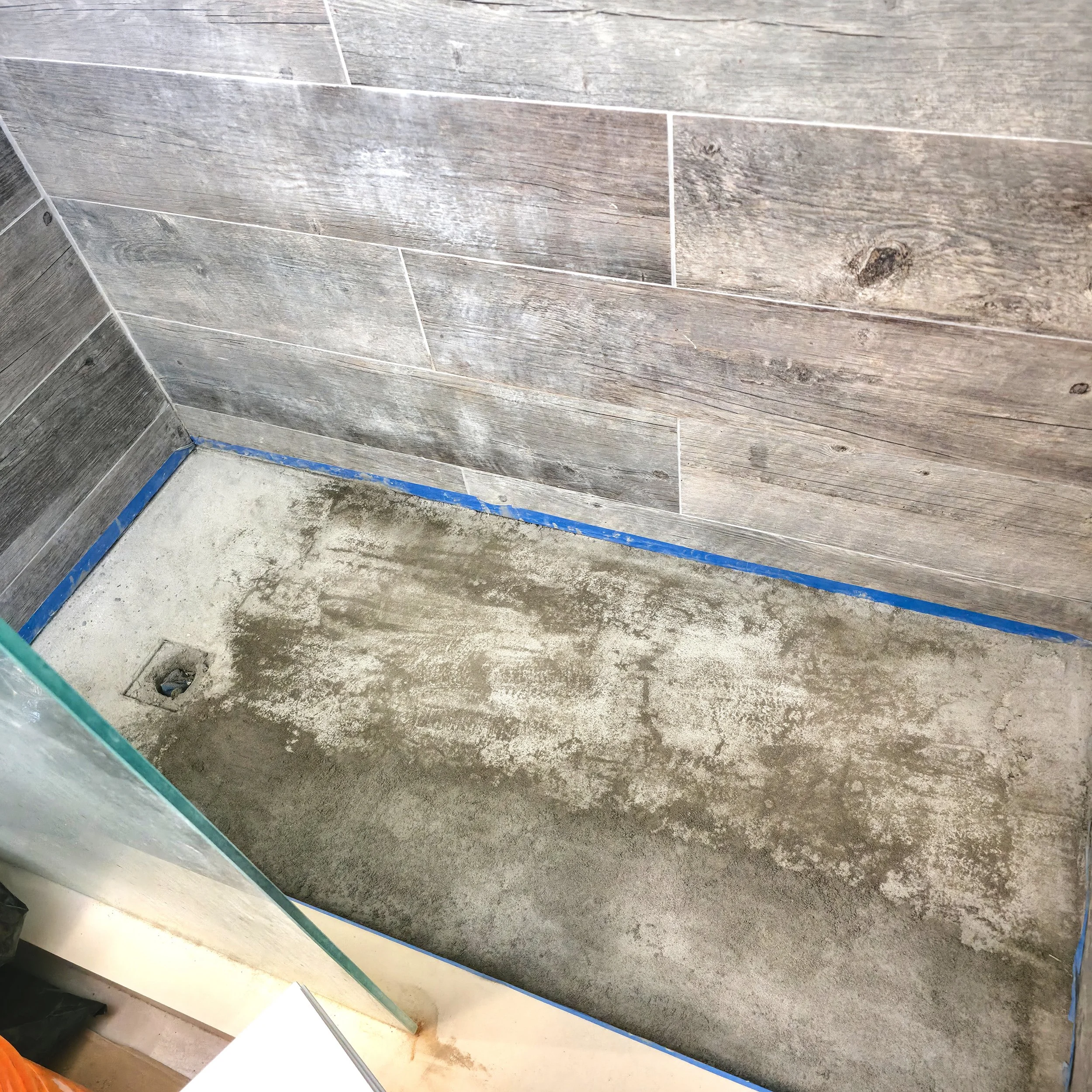 Bathroom renovation in Richmond Hill, Ontario, the new sub-base (deck mud) has been poured to create the correct slope