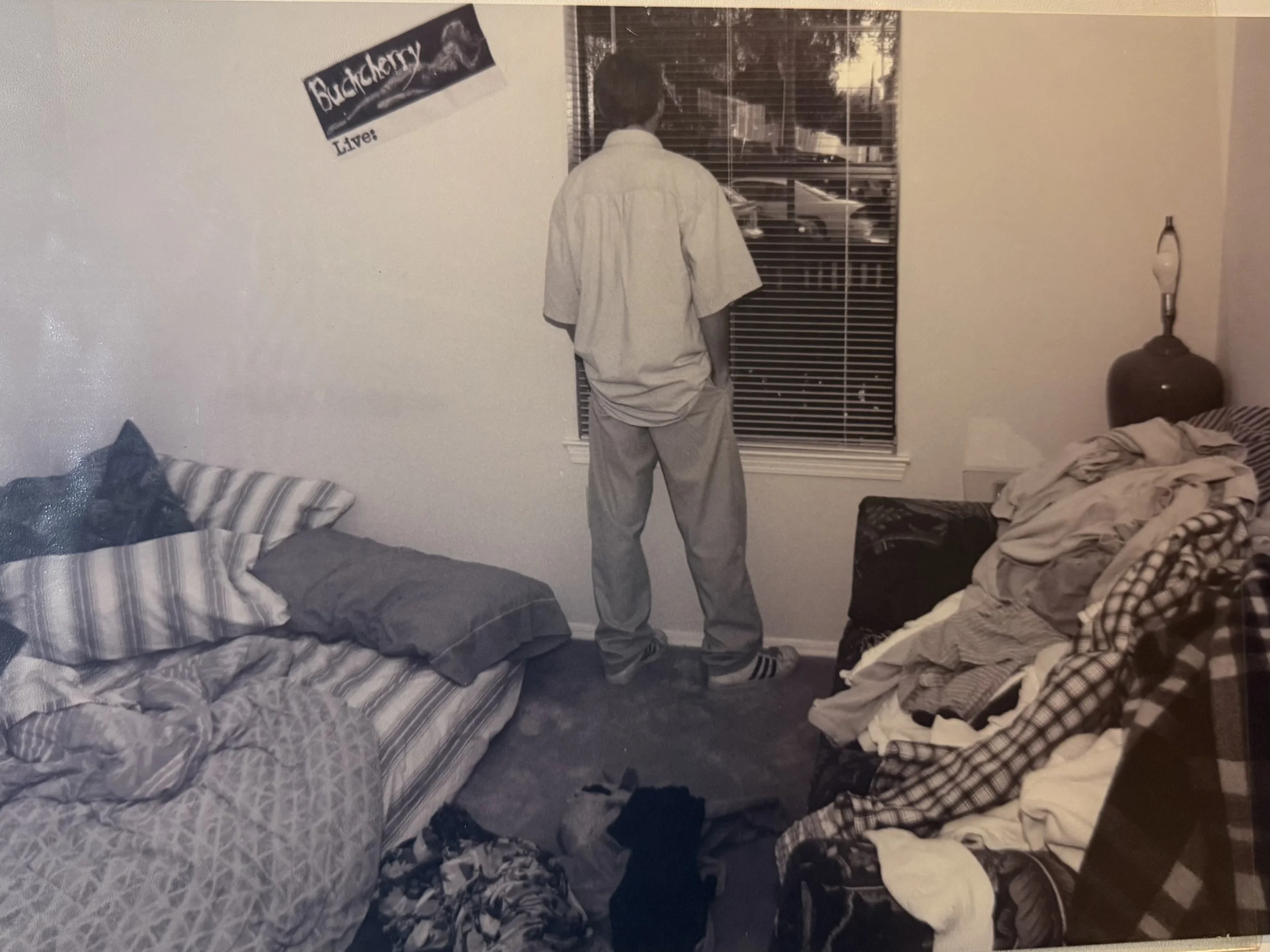 I began exploring environmental portraiture around 1993–94, using 35mm film to photograph people in the spaces they actually lived in. I was interested in what rooms, objects, posture, and ordinary surroundings could reveal about a person that a trad