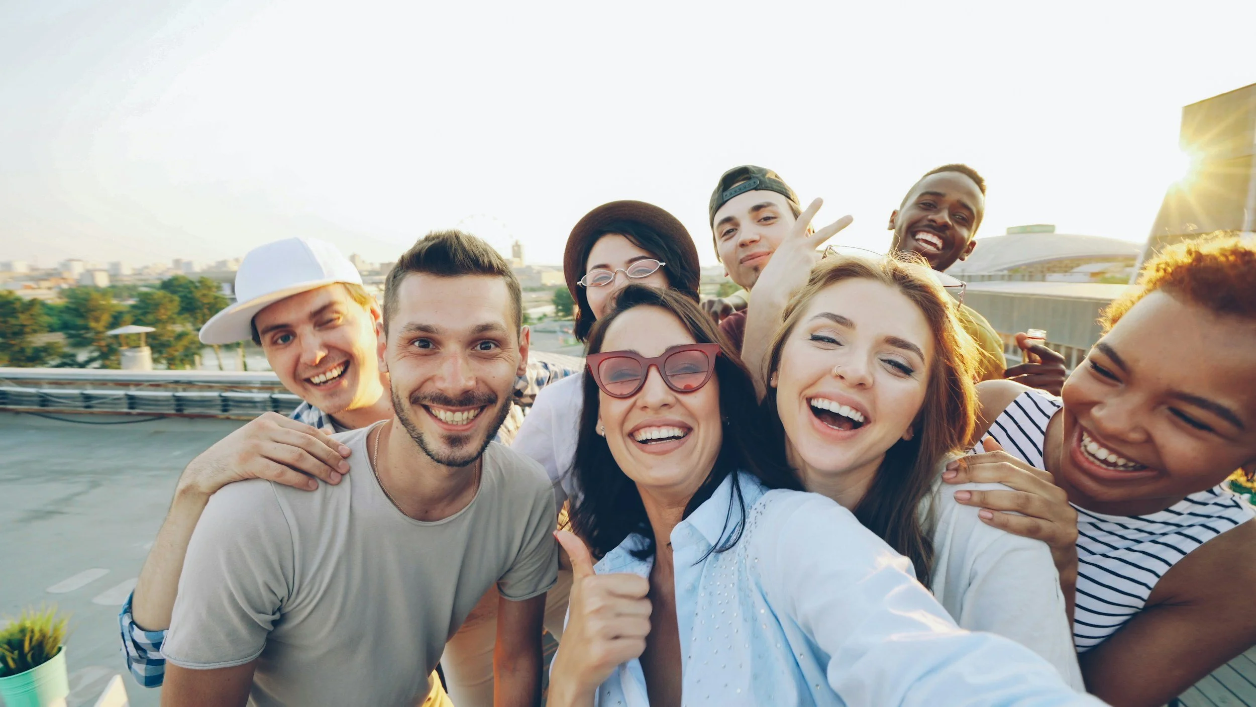Group of people taking a selfie with smiles on their faces