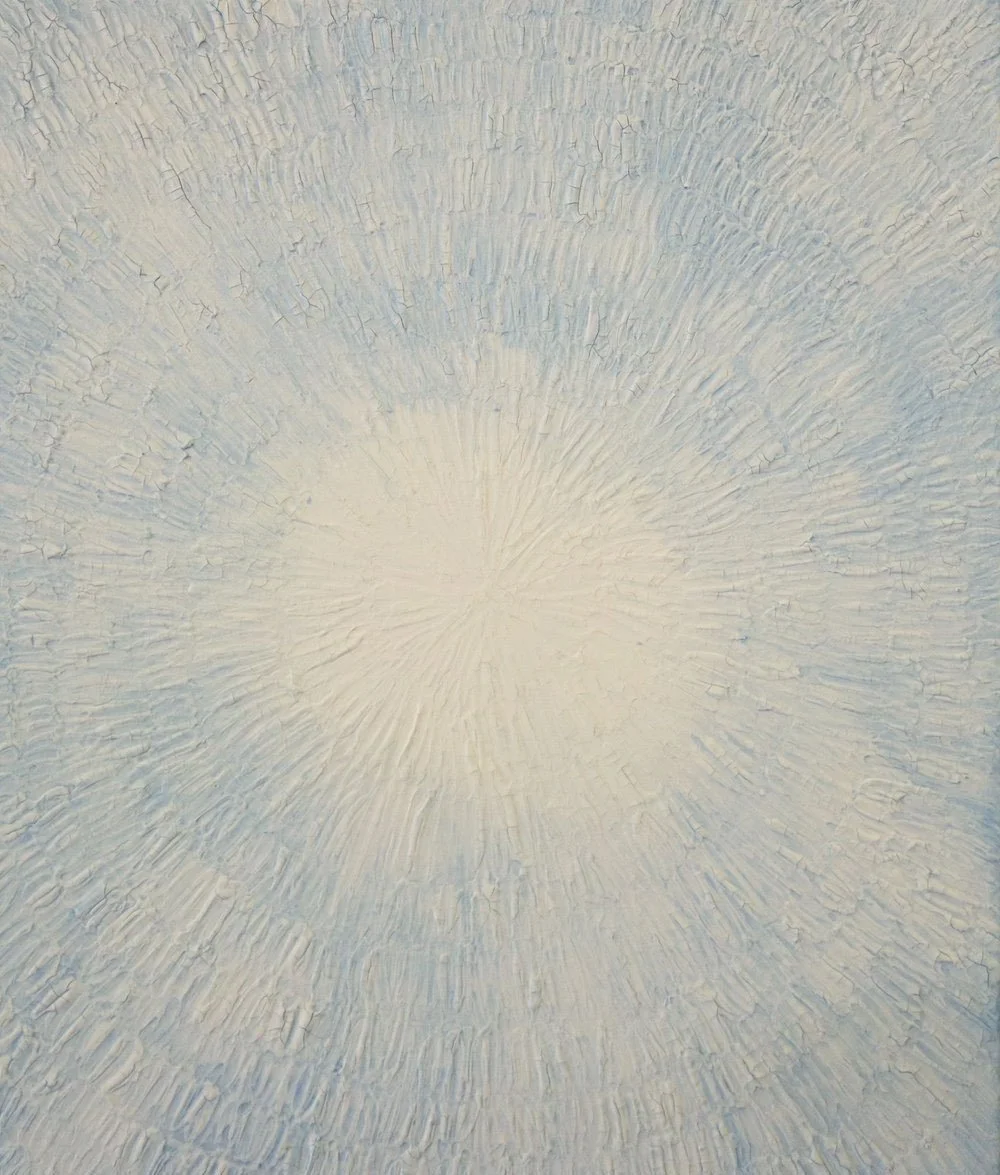 Close-up view of a white textured painting with a sunburst pattern radiating from the center.