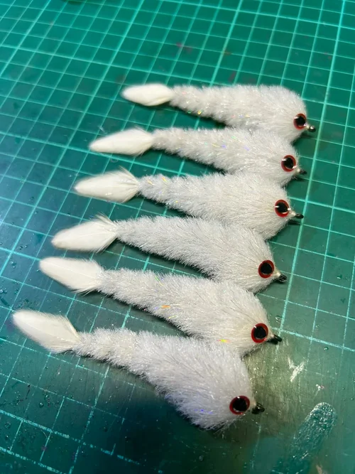 Hand-tying premium predator flies at Megafin Brush and Fly Co — precision craft