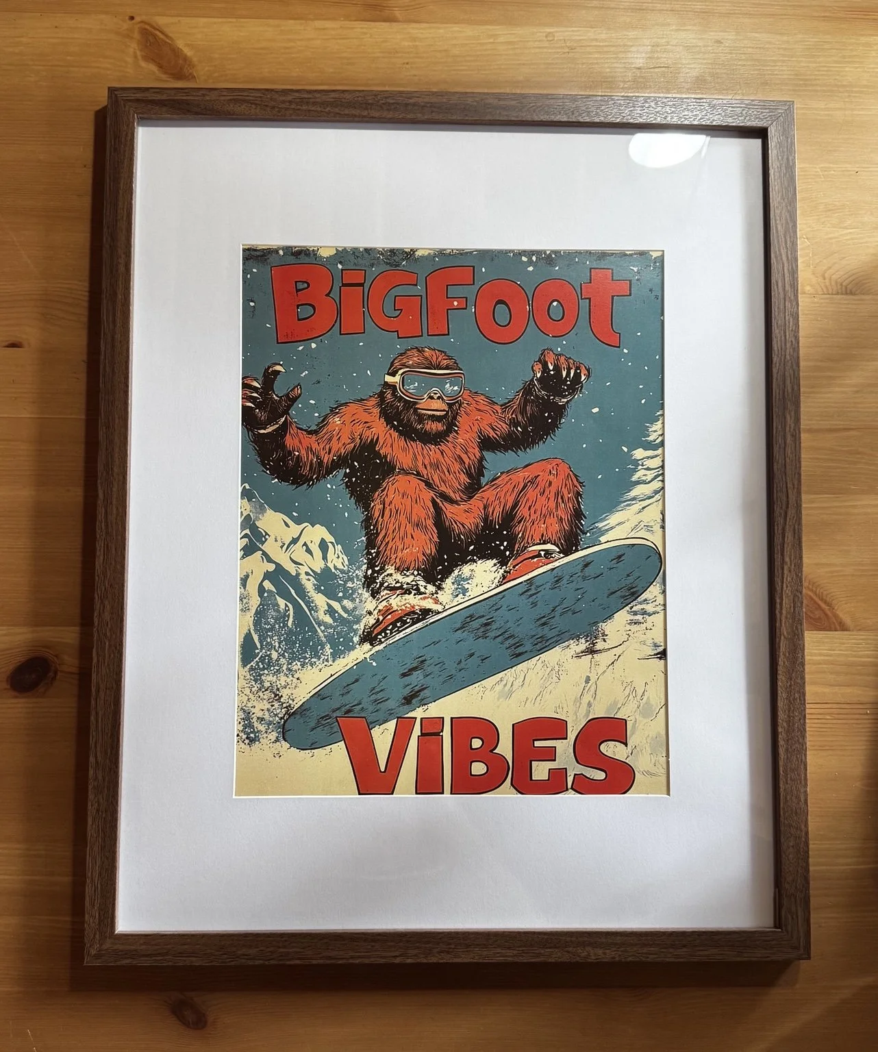 A vintage-style poster of Bigfoot snowboarding with the text 'Bigfoot Vibes' in bold red letters.