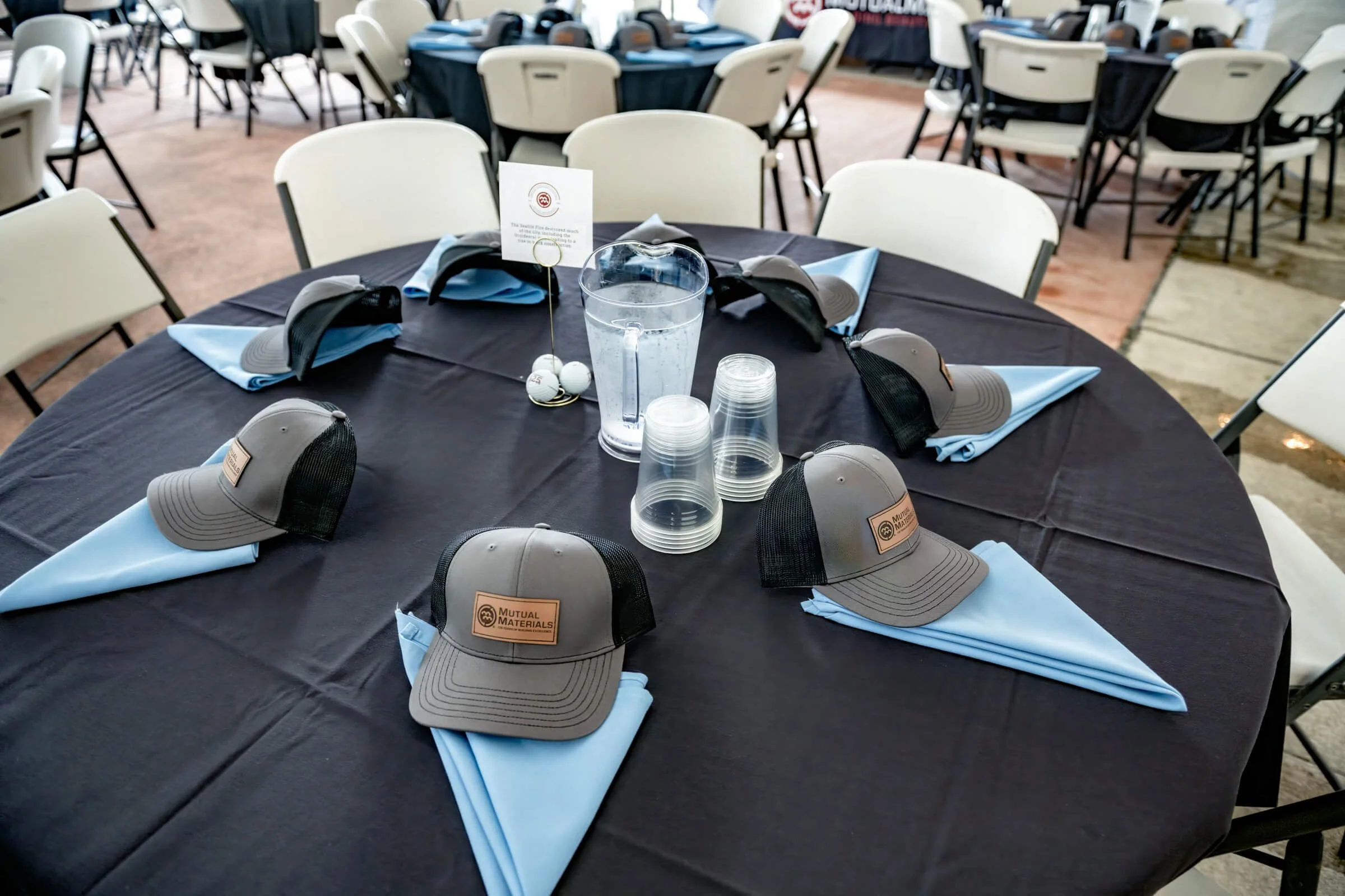 Complete tabletop display featuring branded leather-patch hats and custom table toppers