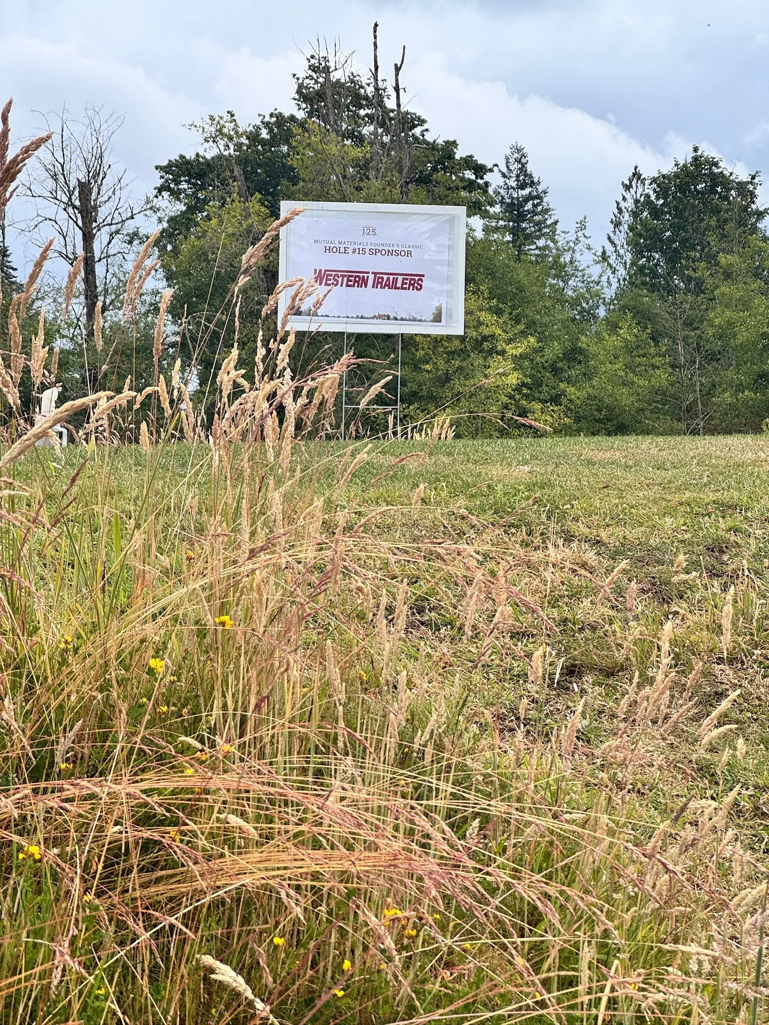 Hole sponsor signs designed by me, with printing and framing handled by the team.