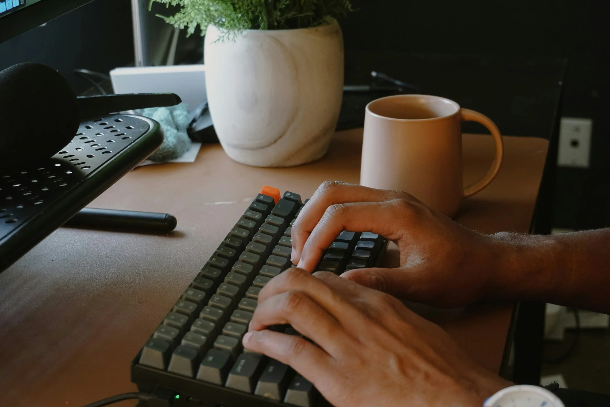 A person typing on a mechanical keyboard