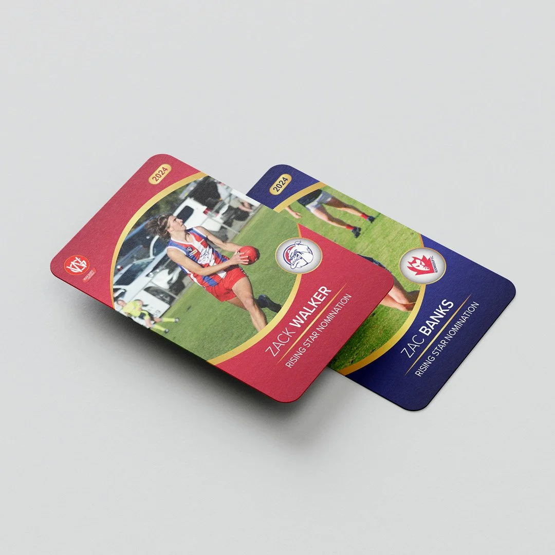 Two sports trading cards on a white surface, one featuring a female football player in a red and blue uniform holding a football, and the other partially visible in blue. Both cards are labeled with the year 2024 and include the name Zac Walker and Zac Banks, indicating they are rising star nominees.