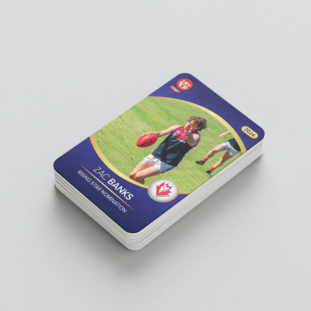 Stack of trading cards featuring Zac Banks, a rising star athlete, holding a red football on a grassy field, with a team logo and the year 2024.