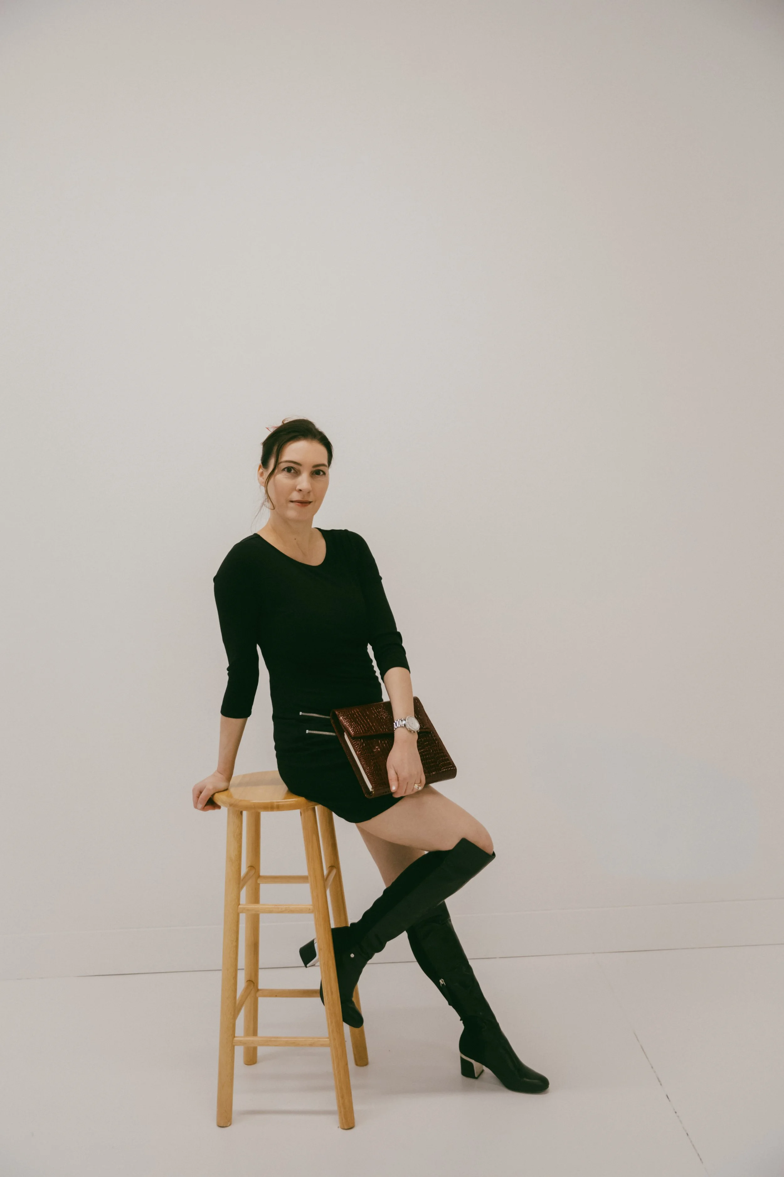 Dr. Kat seated in studio portrait representing private Biological Leadership mentorship for established high-performing professionals and executives.