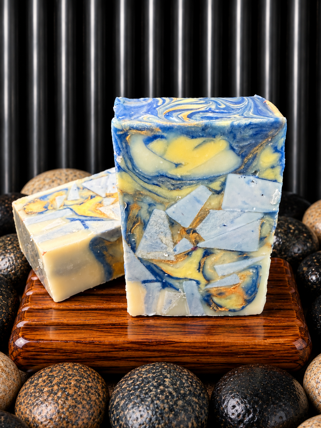 Blue swirl soaps on a wooden dish.png