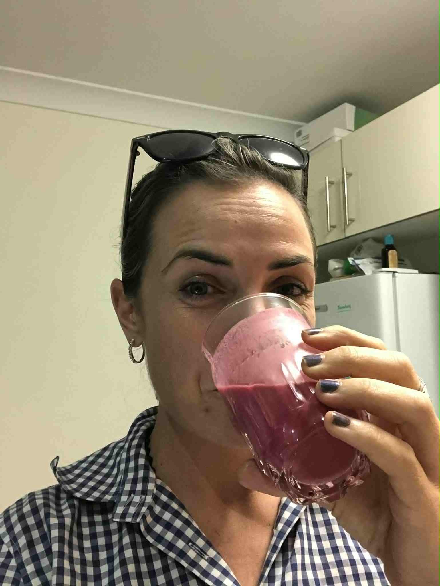 Happy client, drinking one of her healthy supplements. 