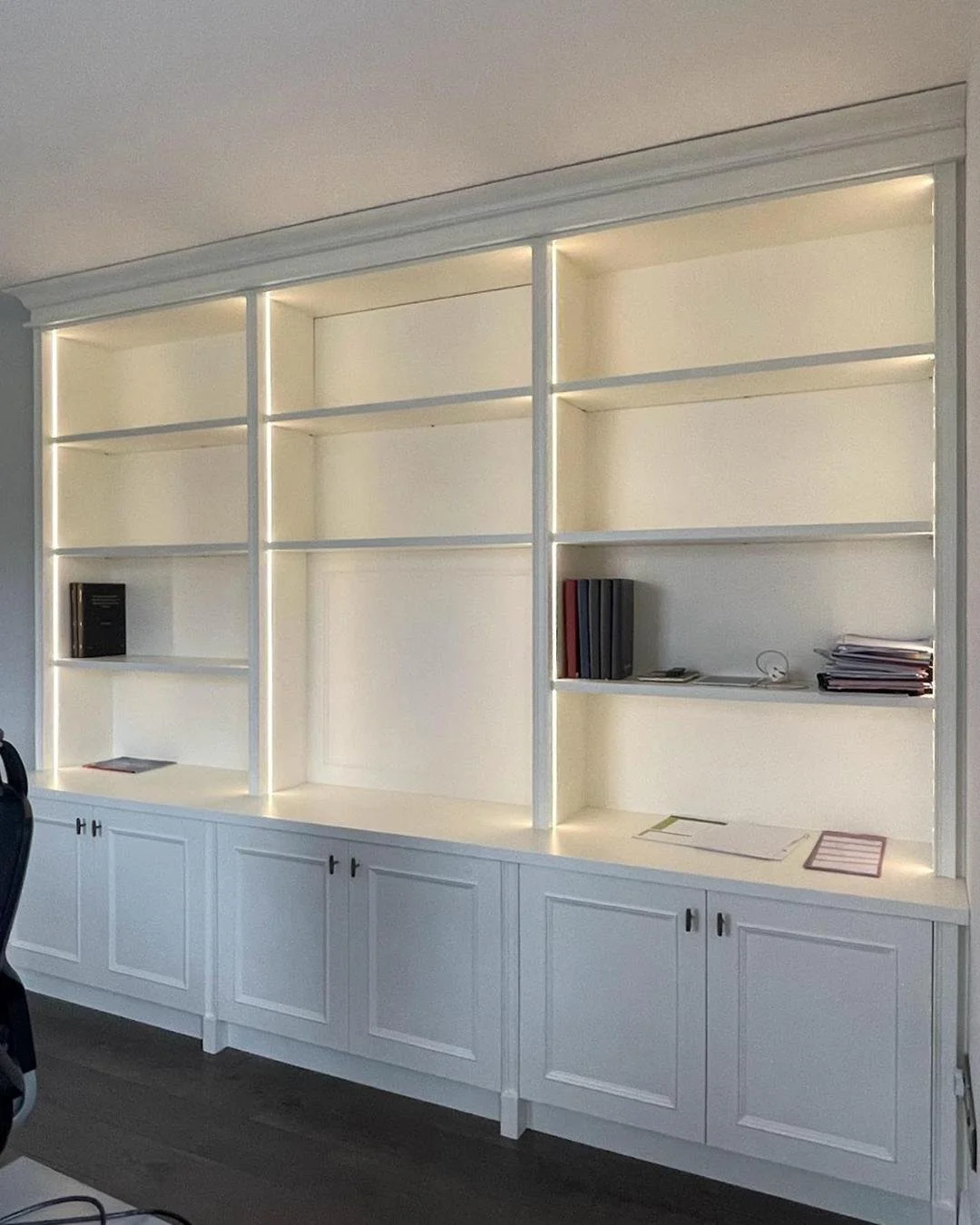 Workspaces that capture different moods but share one purpose - making every workday feel effortless. With Wimborne White cabinetry and oak interiors, one design feels bright, open, and inviting. Closed shaker-style cabinets and soft vertical lightin