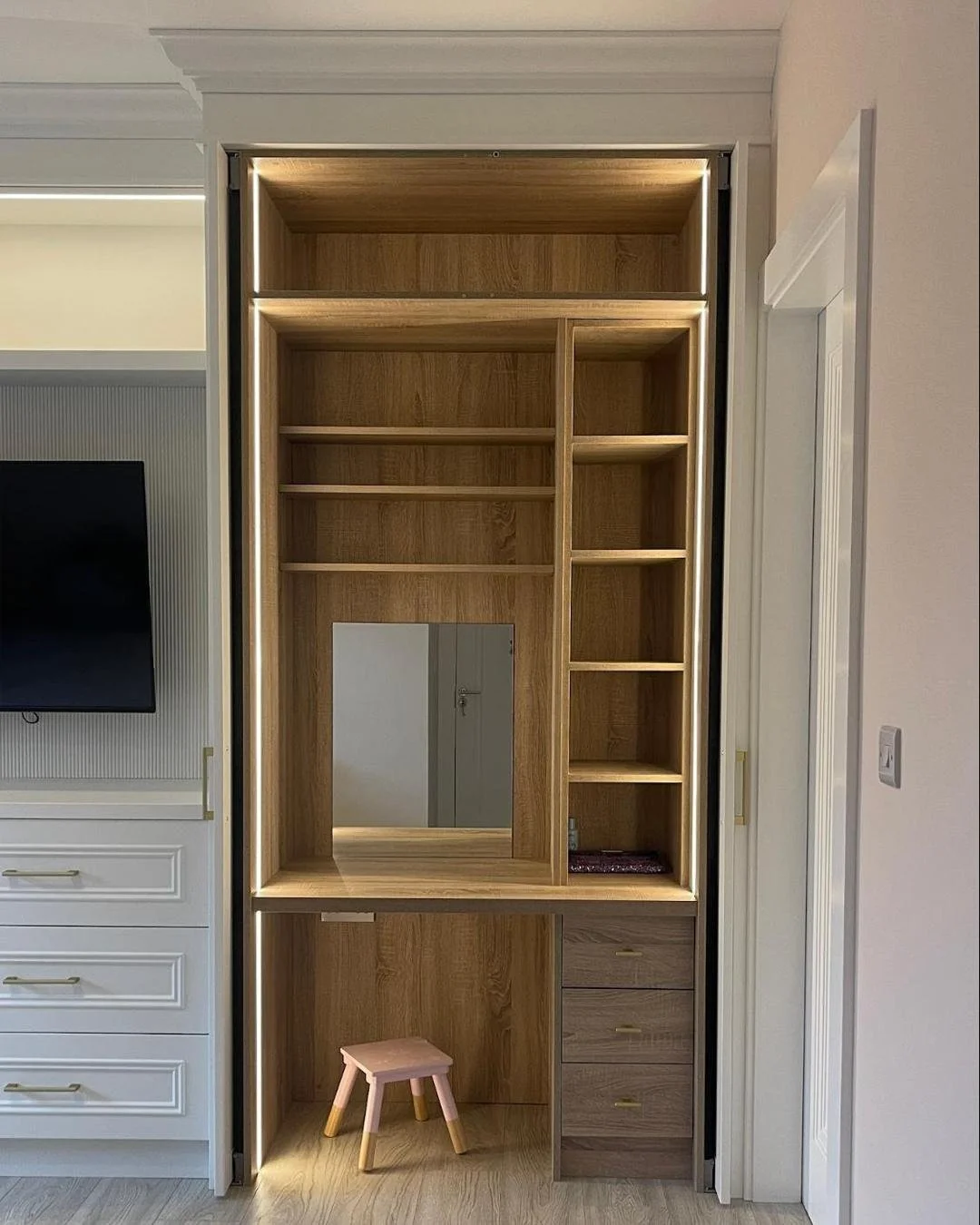 This is our client's little girl&rsquo;s wardrobe, designed to grow with her and make everyday moments feel special. The Brilliant White finish keeps the room bright and calm, while the oak interior adds warmth to her hidden vanity - revealed with a 