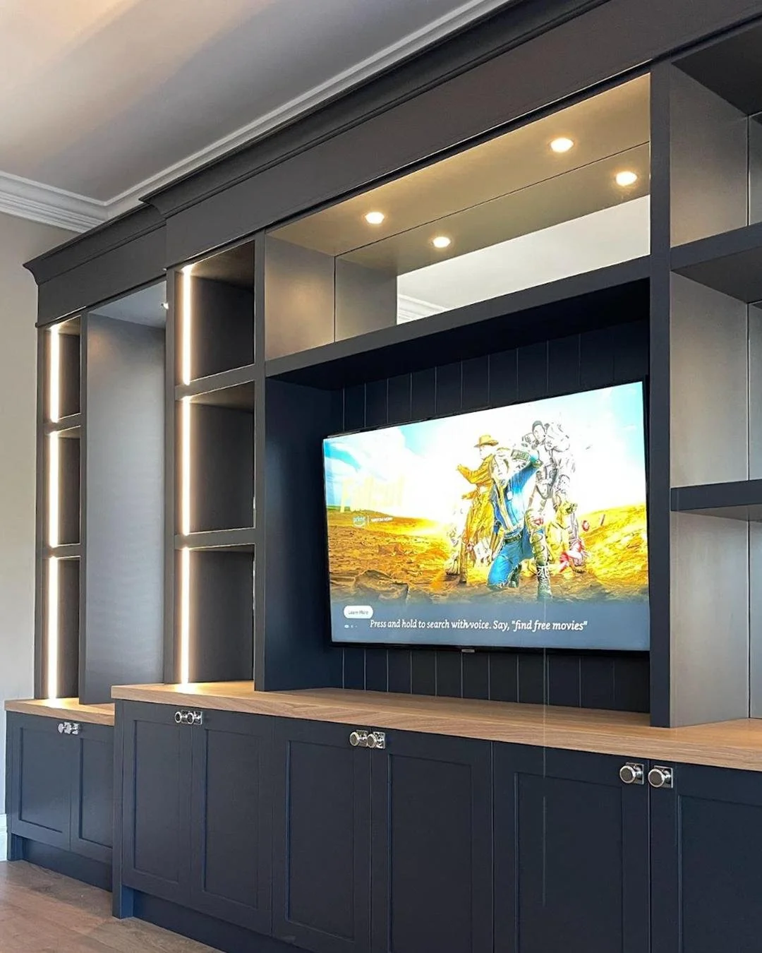 Finished in Hague Blue with a warm oak worktop and oak interiors, this media wall keeps essentials organised, while the floating shelves and soft lighting create a bright, inviting focal point. The design works naturally around the window, letting da