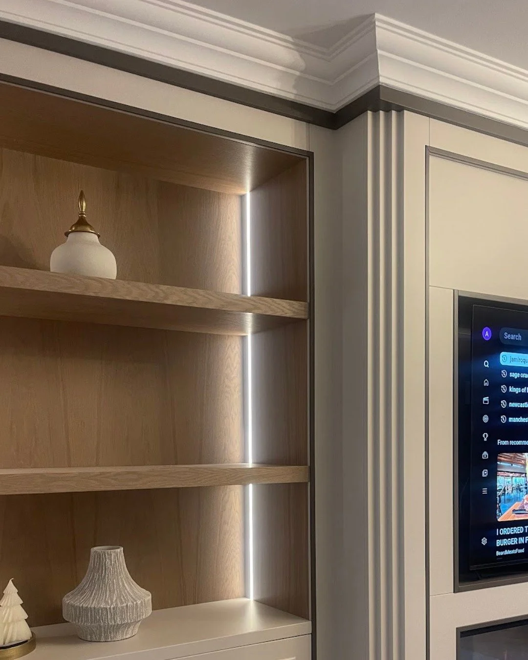 In most homes, the living room ends up doing a bit of everything. This media wall is finished in Farrow &amp; Ball&rsquo;s &lsquo;Skimming Stone&rsquo; to keep the space feeling light, while a &lsquo;London Clay&rsquo; inlay adds depth and contrast. 